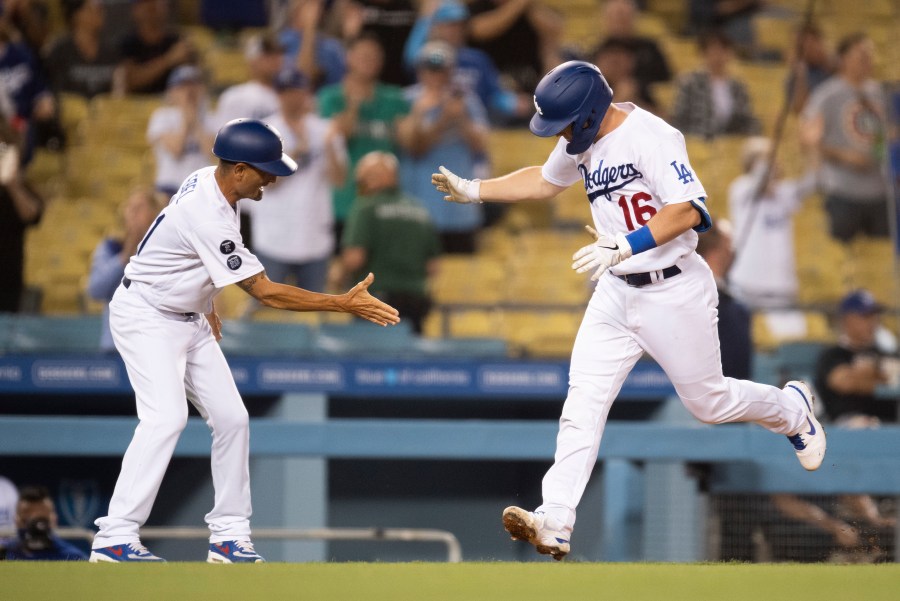 Los Angeles Dodgers' Will Smith, right, celebrates his two-run home run with third base coach Dino Ebel during the fourth inning of a baseball game against the Philadelphia Phillies in Los Angeles on June 14, 2021. (AP Photo/Kyusung Gong)