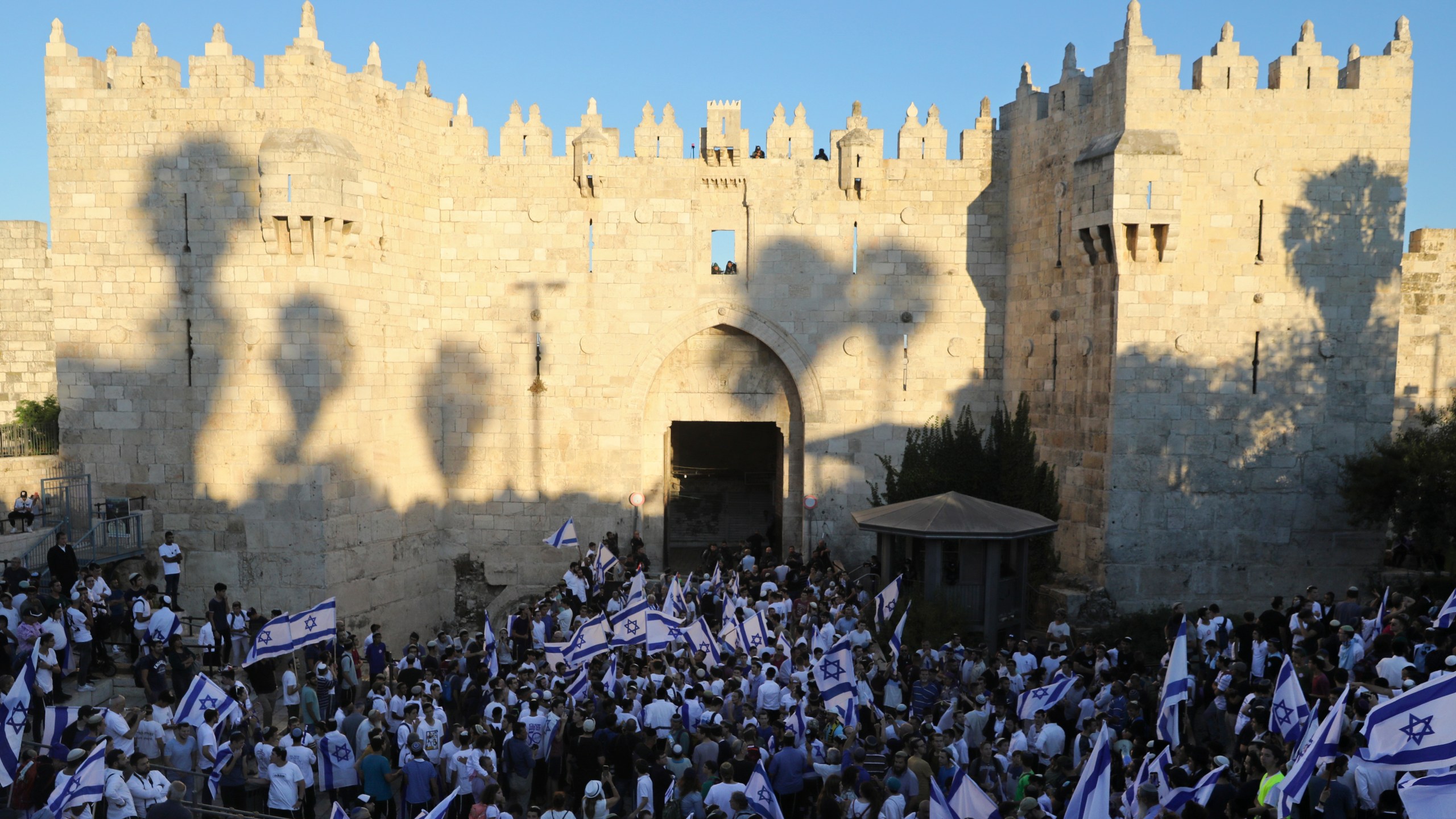 Jewish ultranationalists wave Israeli flags during the "Flags March," next to Damascus gate, outside Jerusalem's Old City on June 15, 2021. (AP Photo/Mahmoud Illean)