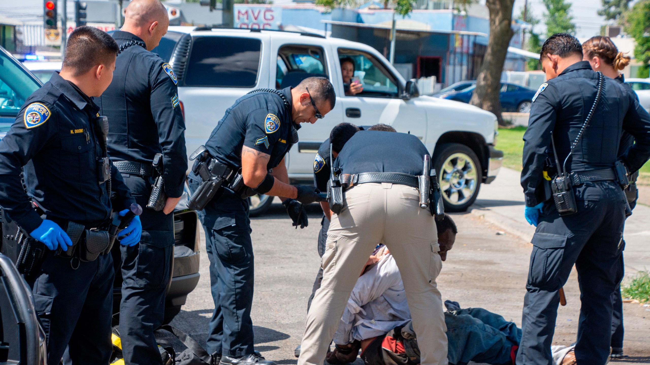 In this Friday, May 21, 2021, photo, Bakersfield Police Department officers respond to an incident at Martin Luther King Jr. Park in southeast Bakersfield, Calif. (Anne Daugherty/California Reporting Project via AP)