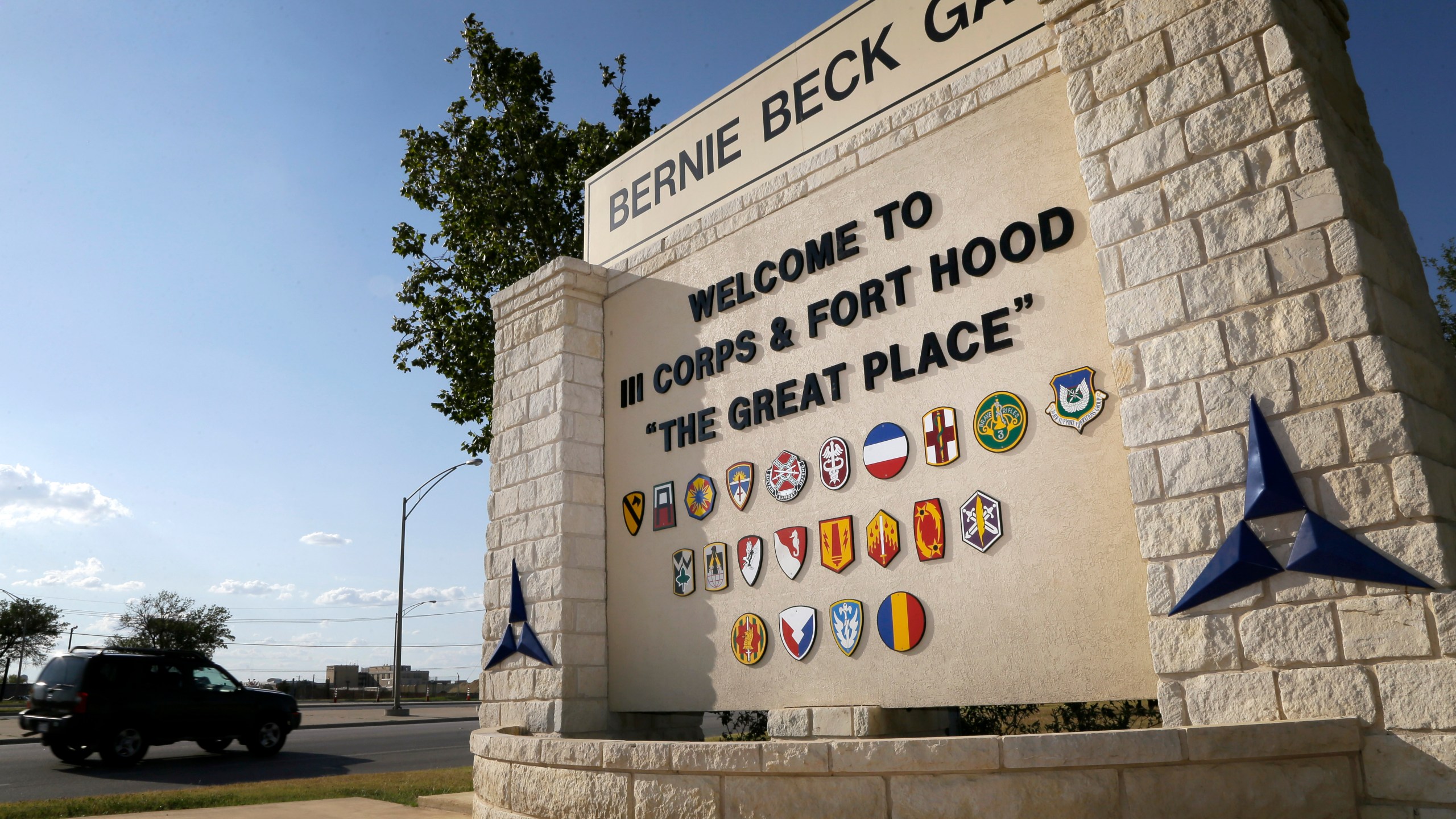 In this July 9, 2013, file photo, traffic flows through the main gate past a welcome sign in Fort Hood, Texas. A new study finds that female soldiers at Army bases in Texas, Colorado, Kansas and Kentucky face a greater risk of sexual assault and harassment than those at other posts, accounting for more than a third of all active duty Army women sexually assaulted in 2018. The study by RAND Corporation was released Friday. (AP Photo/Tony Gutierrez, File)