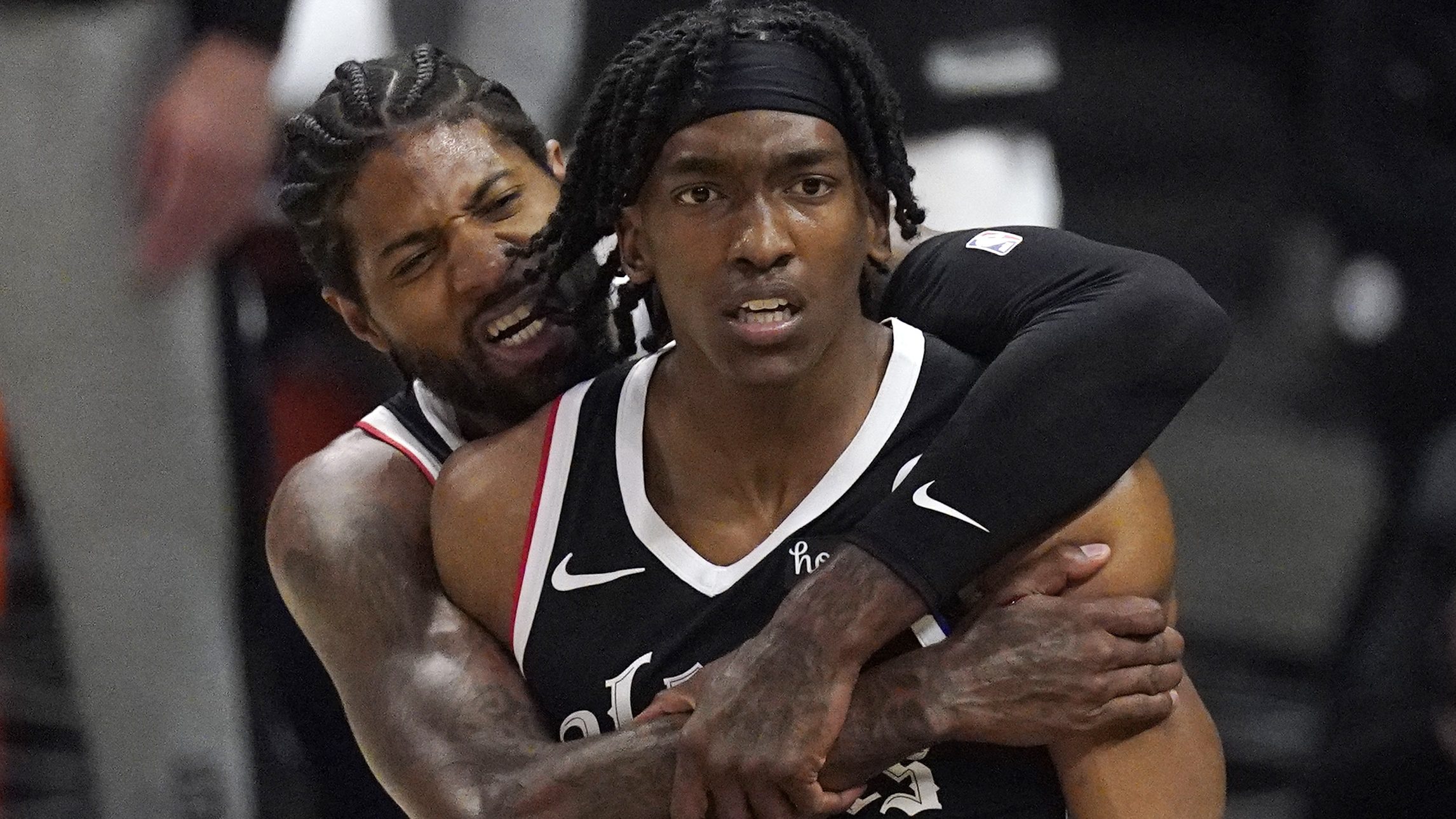 Los Angeles Clippers guard Terance Mann, right, celebrates with guard Paul George after scoring and drawing a foul during the first half in Game 6 of a second-round NBA basketball playoff series against the Utah Jazz on June 18, 2021. (Mark J. Terrill / Associated Press)