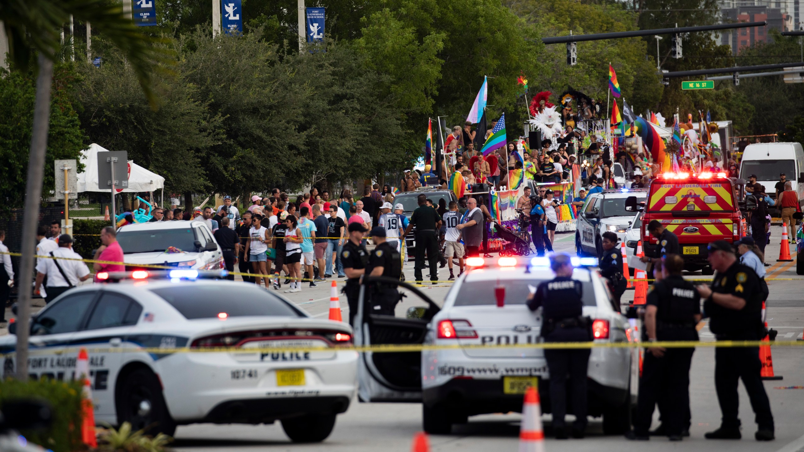 Police and firefighters respond after a truck drove into a crowd of people injuring them during The Stonewall Pride Parade and Street Festival in Wilton Manors, Fla., on Saturday, June 19, 2021. WPLG-TV reports that the driver of the truck was taken into custody. (Chris Day/South Florida Sun-Sentinel via AP)