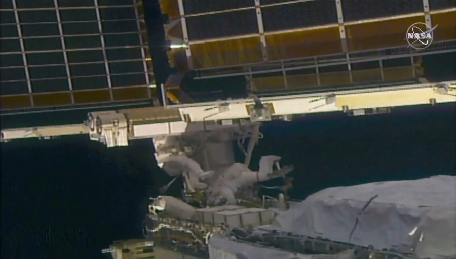 In this image taken from NASA video, NASA astronaut Shane Kimbrough, left, and French astronaut Thomas Pesquet work on the solar array outside the International Space Station, Sunday, June 20 2021. (NASA via AP)