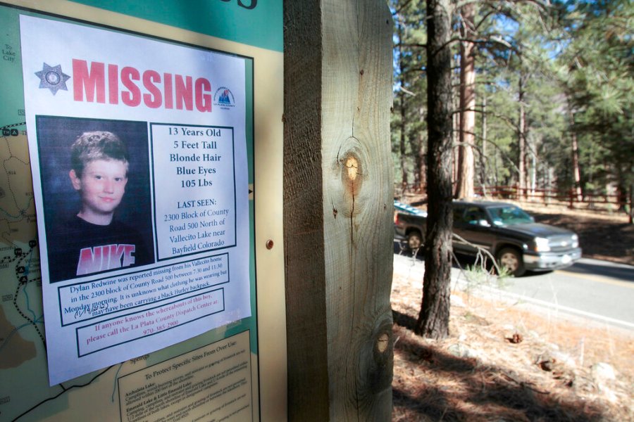 In this Nov. 26, 2012, file photo, a missing poster of 13-year-old Dylan Redwine hangs on a trail head sign next to Vallecito Reservoir in Vallecito, Colorado.(Shaun Stanley/The Durango Herald via AP, File)