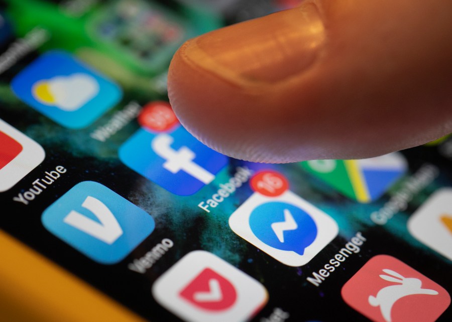 This Aug. 11, 2019, file photo an iPhone displays the apps for Facebook and Messenger in New Orleans. (AP Photo/Jenny Kane, File)