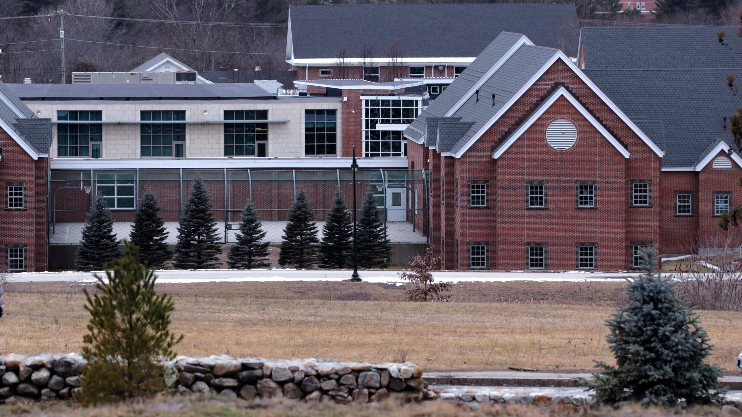 In this Jan. 28, 2020, file photo is the Sununu Youth Services Center in Manchester, N.H. As states from California to Maine consider drastic changes to youth detention centers, New Hampshire is grappling with its own facility that has been rocked by abuse allegations from years past. The state’s Legislature will vote Thursday on a proposed state budget that would close the sprawling facility — housing fewer than 20 children on a campus built for 144 — by March 2023 and replace it with a new 18-bed center. (AP Photo/Charles Krupa, File)