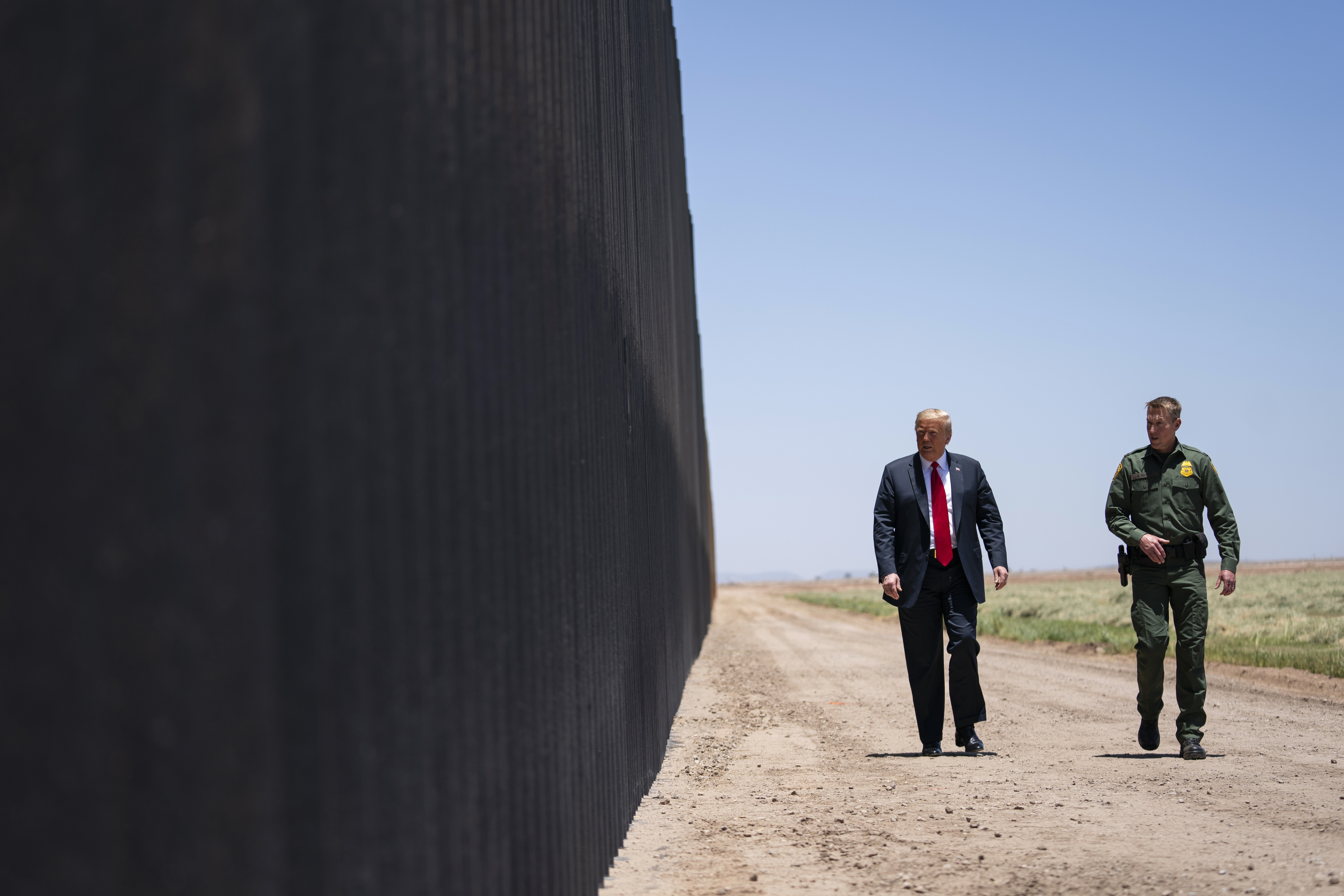 In this June 23, 2020 file photo, U.S. Border Patrol chief Rodney Scott gives President Donald Trump a tour of a section of the border wall in San Luis, Ariz. (Evan Vucci/Associated Press)