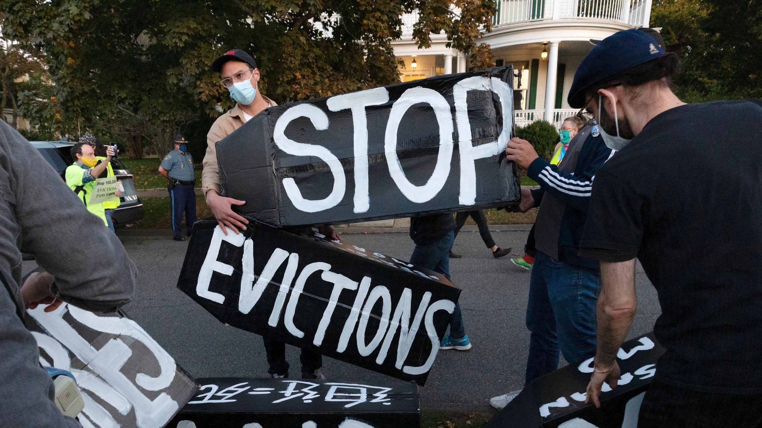 In this Oct. 14, 2020, file photo, housing activists erect a sign in Swampscott, Mass. A federal freeze on most evictions is set to expire soon. The moratorium, put in place by the Centers for Disease Control and Prevention in September, was the only tool keeping millions of tenants in their homes. (AP Photo/Michael Dwyer, File)