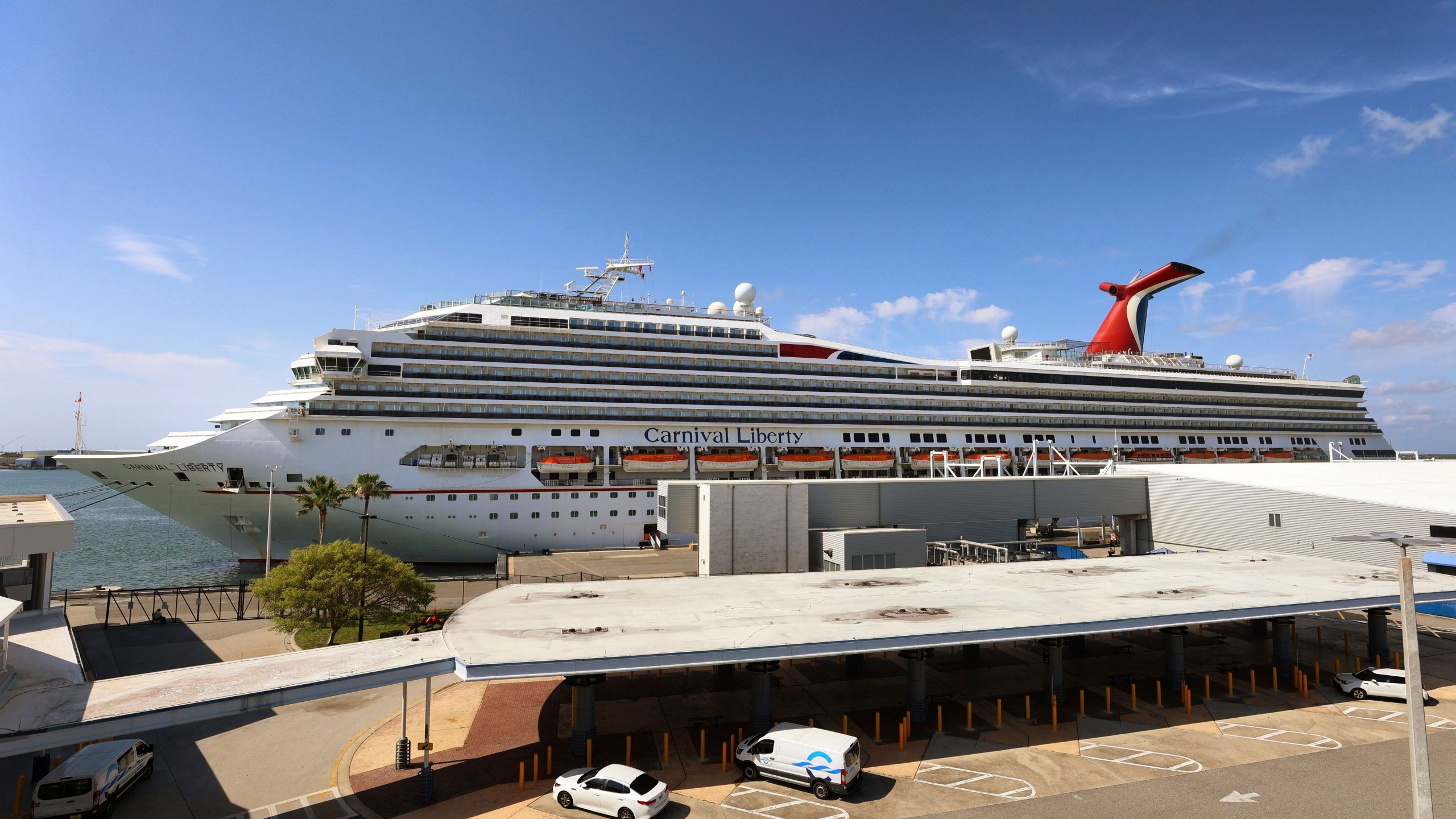 In this Wednesday, May 12, 2021, file photo, the Carnival Cruise ship "Liberty" is docked at Port Canaveral, Fla. Carnival Corp. continues to lose billions while it waits for cruising to recover from the pandemic. Carnival said Thursday, June 24, that it lost $2.1 billion in its latest quarter. (Joe Burbank/Orlando Sentinel via AP)