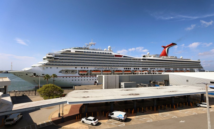 In this Wednesday, May 12, 2021, file photo, the Carnival Cruise ship "Liberty" is docked at Port Canaveral, Fla. Carnival Corp. continues to lose billions while it waits for cruising to recover from the pandemic. Carnival said Thursday, June 24, that it lost $2.1 billion in its latest quarter. (Joe Burbank/Orlando Sentinel via AP)