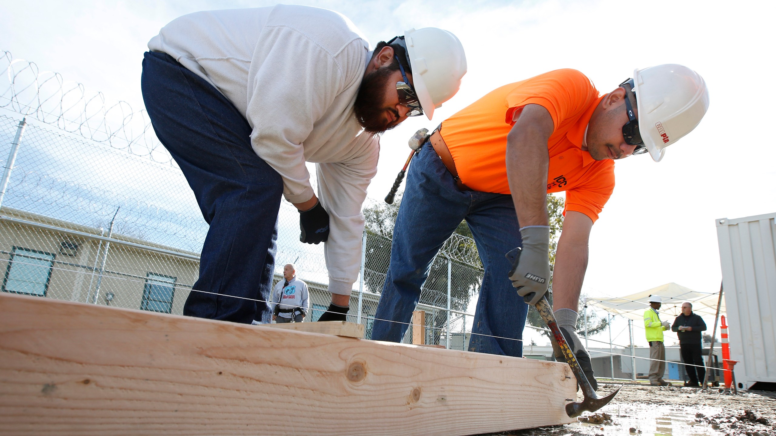 In this Jan. 22, 2019, file photo, youthful offenders Siegmond Navar, left and Gabriel Andalon construct a frame to hold concrete at one of the vocational classes at the O.H. Close Youth Correctional Facility, in Stockton, Calif. California is phasing out its state-run youth prisons and shifting the responsibilities to the counties. The state will not only keep offenders closers to home but transfer oversight form the corrections department to the Health and Human Services Agency. The three remaining state-run lockups, including there O.H Close Youth Correctional Facility, will stop admissions Thursday, July 1 and close for good two years later. (AP Photo/Rich Pedroncelli, File)