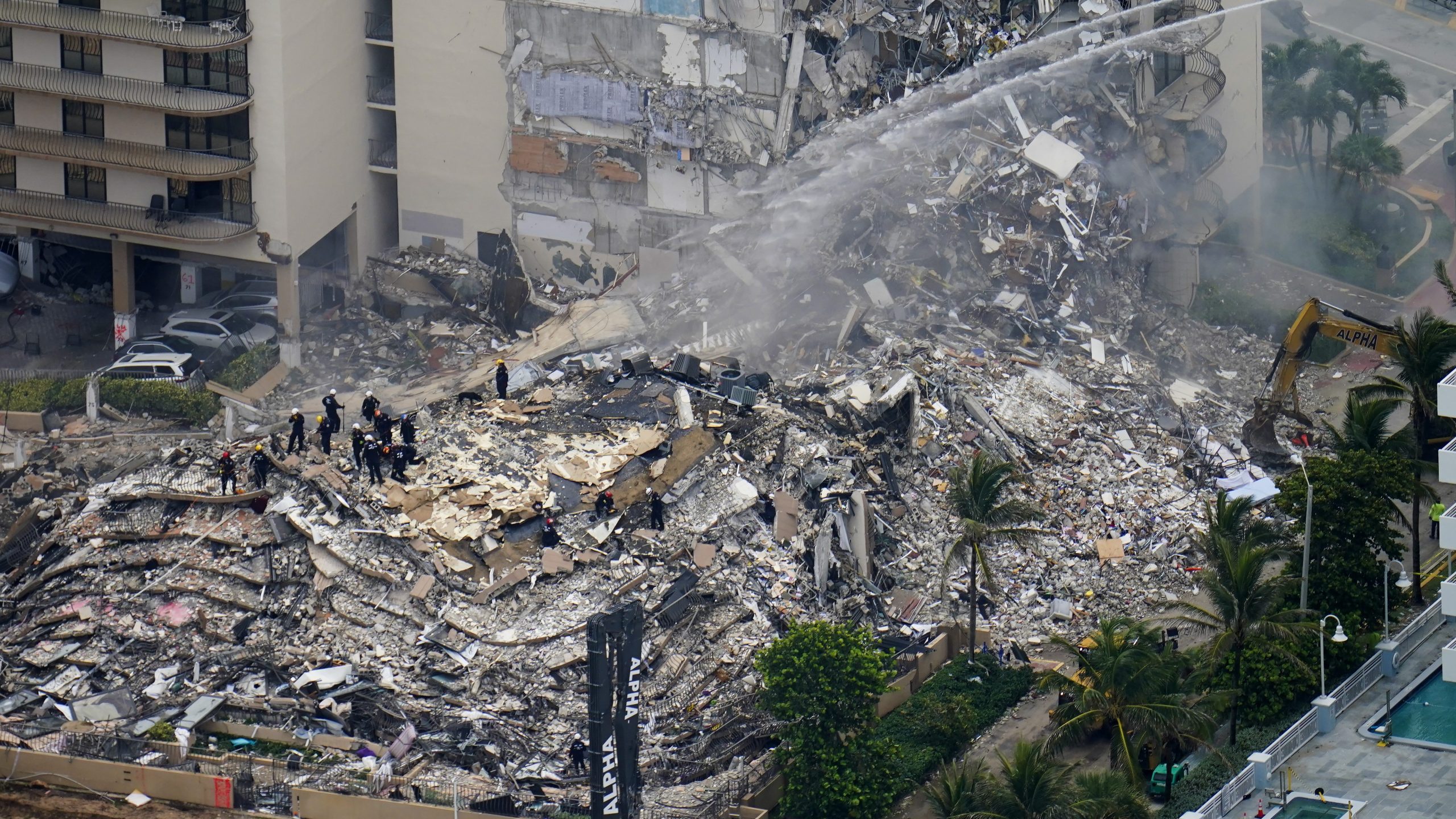 Rescue workers shift through the rubble at the Champlain Towers South Condo in Surfside, Florida, on June 25, 2021, a day after it partially collapsed. (Gerald Herbert / Associated Press)