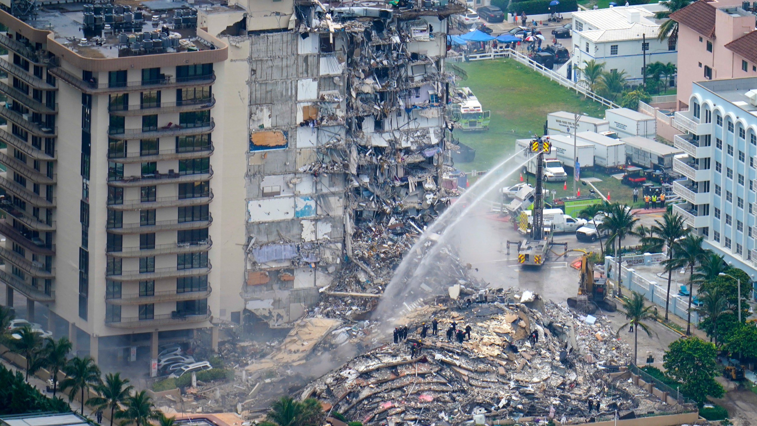 Rescue workers work in the rubble at the Champlain Towers South Condo is seen, Friday, June 25, 2021, in Surfside. The apartment building partially collapsed on Thursday. (AP Photo/Gerald Herbert)