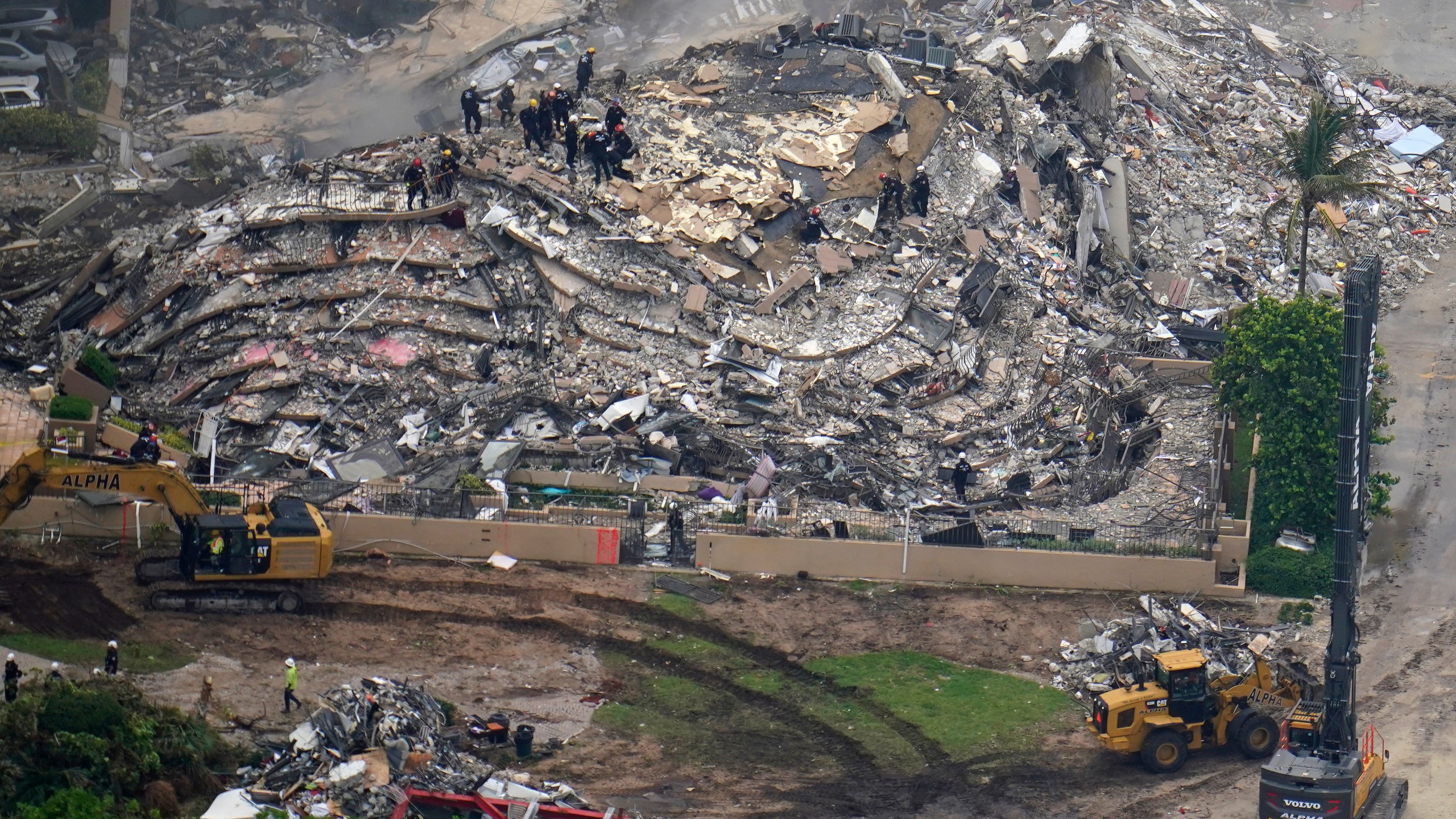 In this aerial image search and rescue workers work the site of an oceanfront condo building that partially collapsed, in Surfside, Fla., Friday, June 25, 2021. (AP Photo/Gerald Herbert)