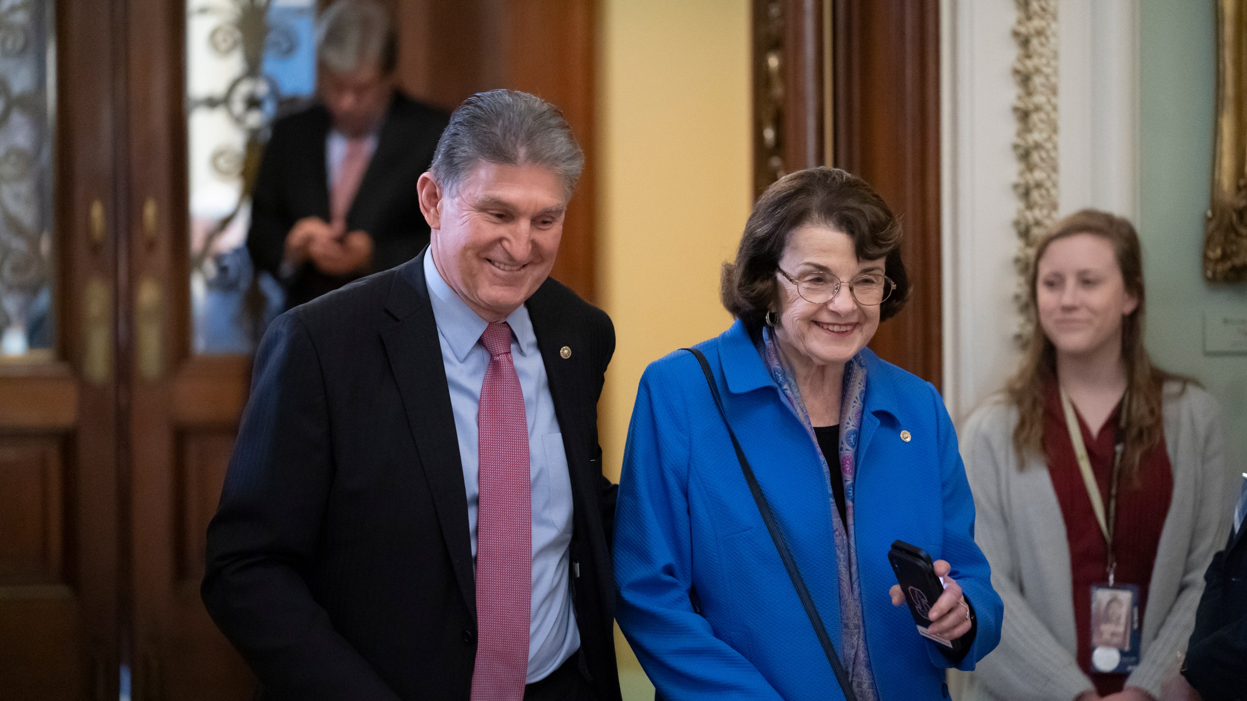 In this Jan. 31, 2020 file photo, Sen. Joe Manchin, D-W.Va., left, and Sen. Dianne Feinstein, D-Calif., walk in the Capitol in Washington. (AP Photo/J. Scott Applewhite)