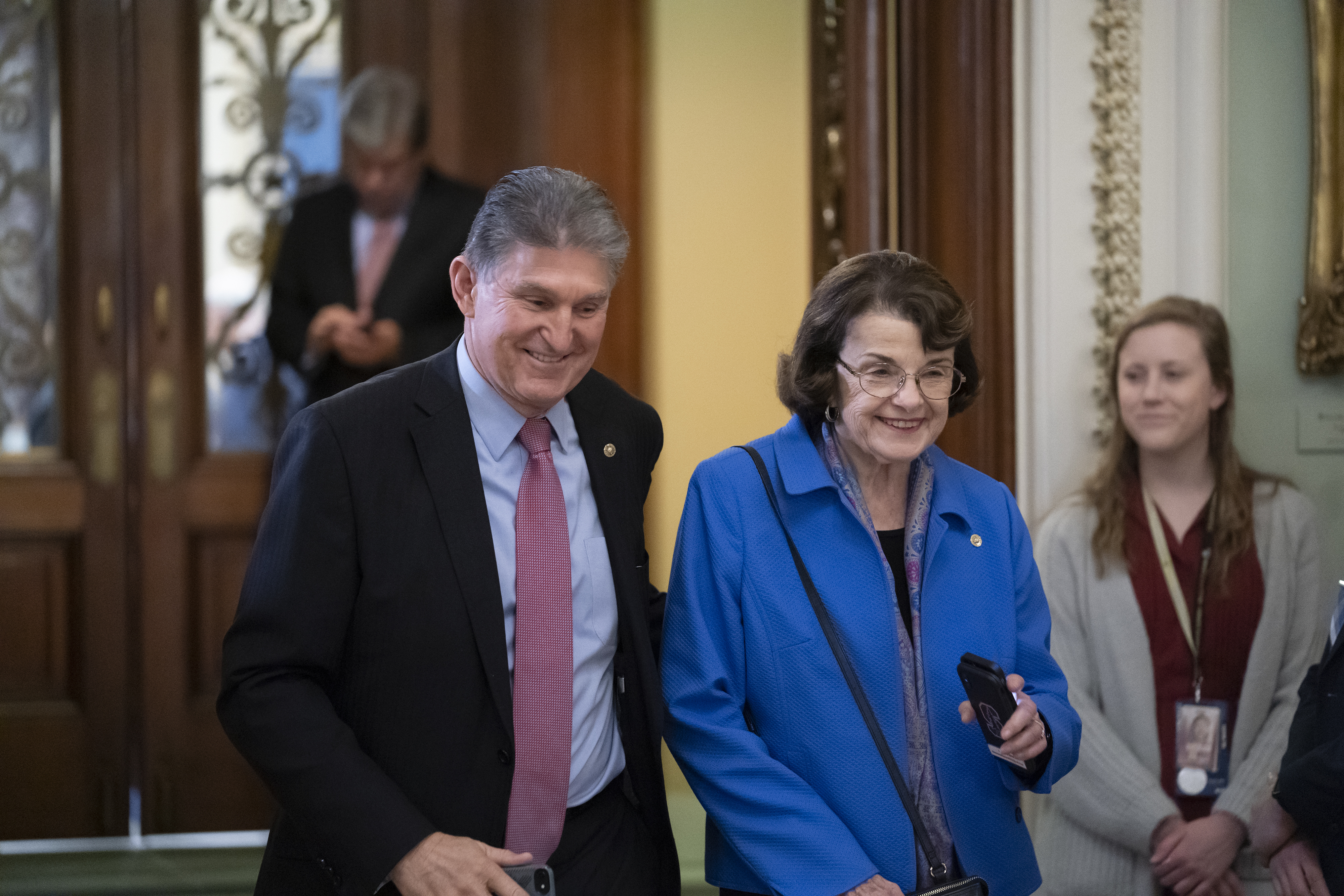 In this Jan. 31, 2020 file photo, Sen. Joe Manchin, D-W.Va., left, and Sen. Dianne Feinstein, D-Calif., walk in the Capitol in Washington. (AP Photo/J. Scott Applewhite)