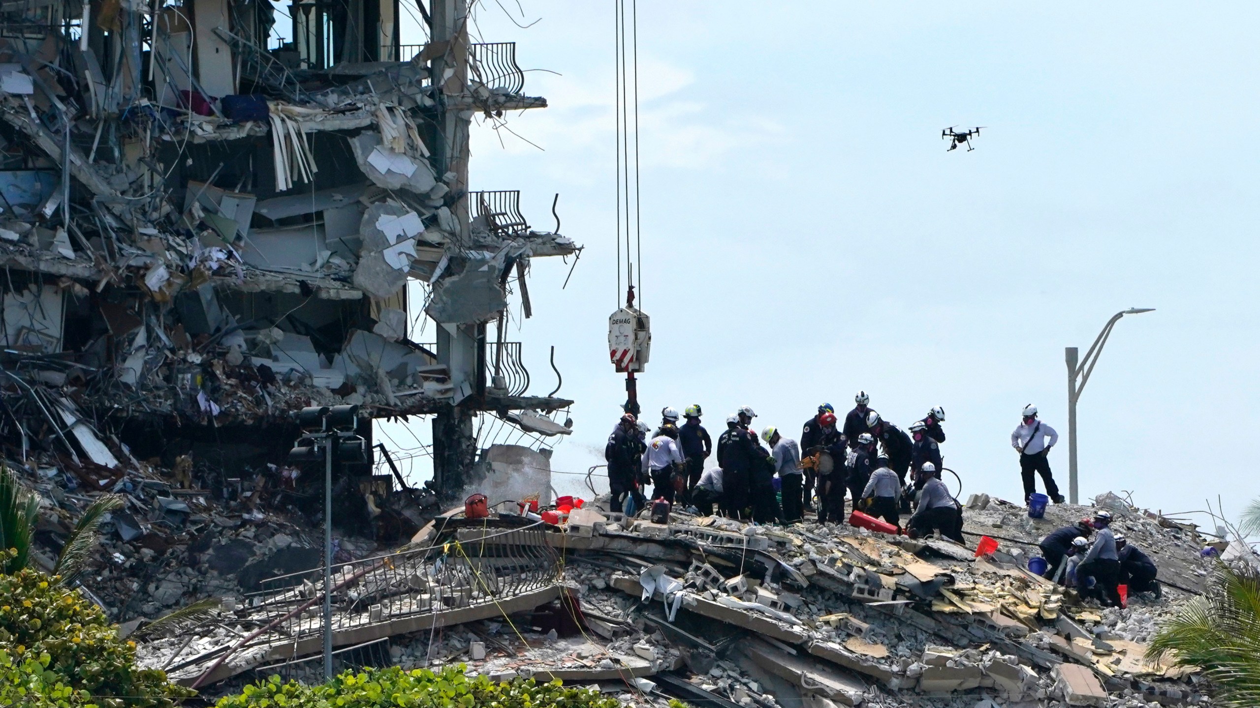 Rescue workers search in the rubble for survivors at the Champlain Towers South condominium, Saturday, June 26, 2021, in the Surfside area of Miami. The building partially collapsed on Thursday. (AP Photo/Lynne Sladky)