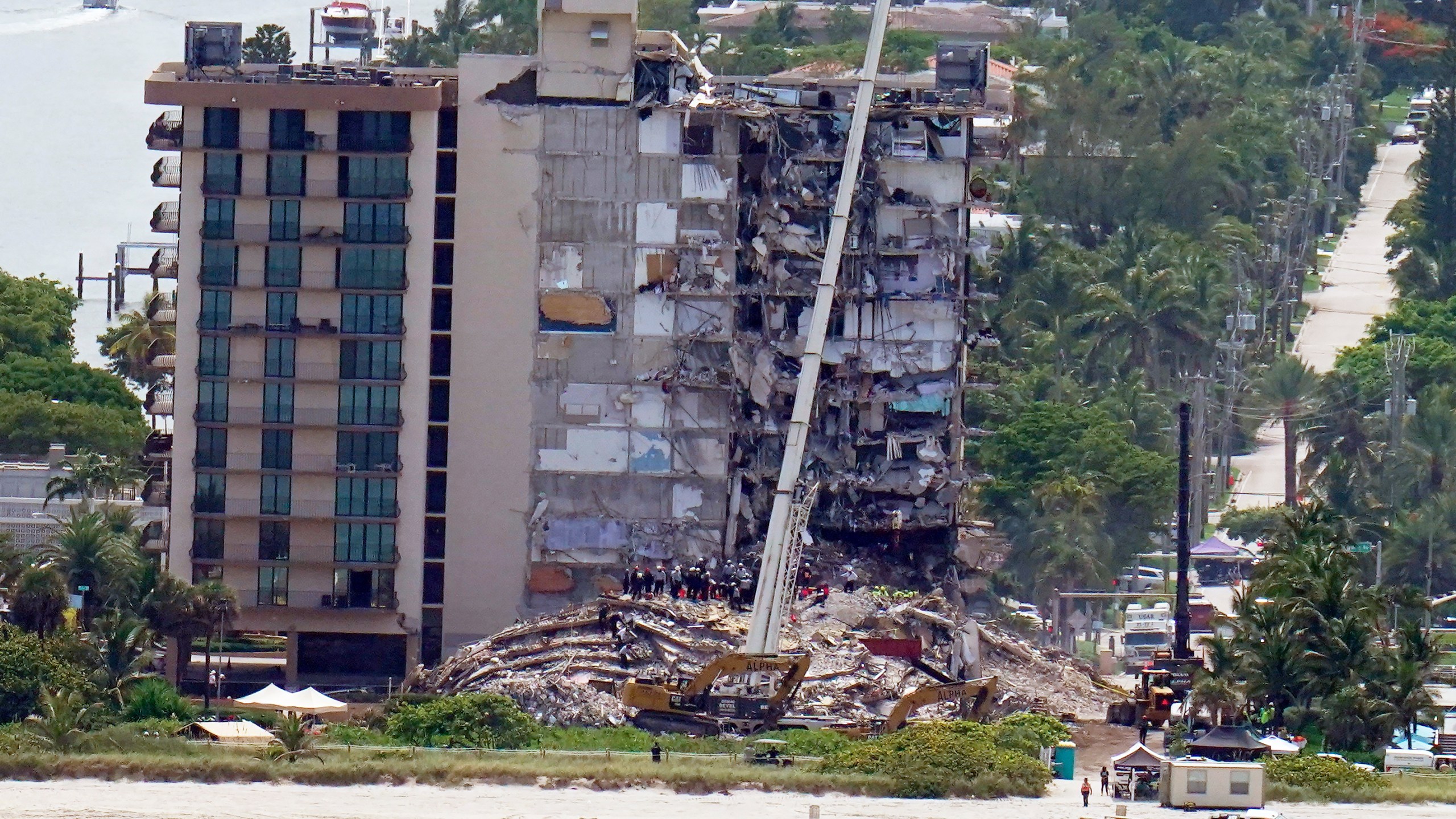 Workers search in the rubble at the Champlain Towers South Condo, Saturday, June 26, 2021, in Surfside, Fla. One hundred fifty-nine people were still unaccounted for two days after Thursday's collapse, which killed at least four. (AP Photo/Gerald Herbert)