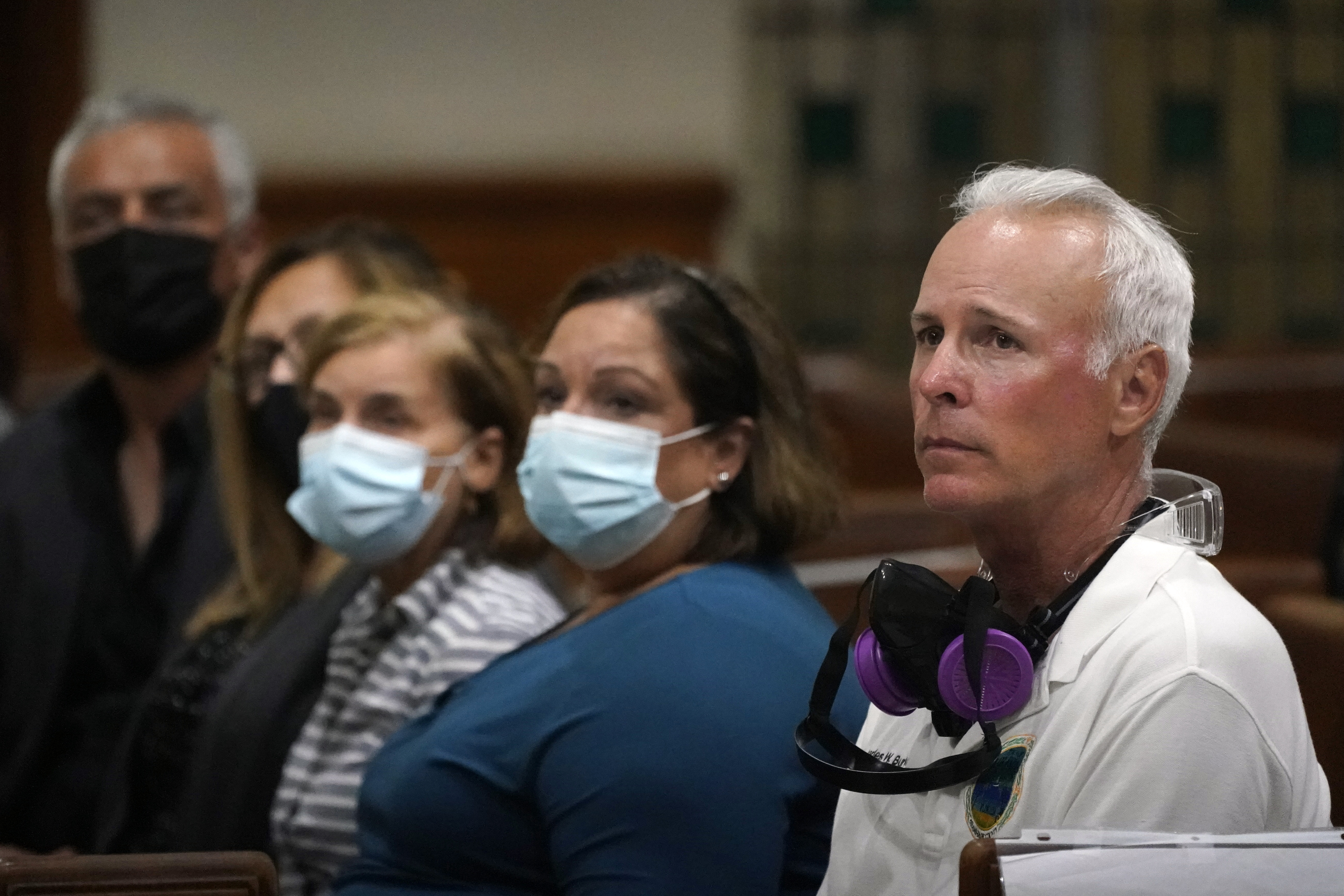 Surfside, Fla., Mayor Charles Burkett, right, joins worshipers, late Saturday, June 26, 2021, during a prayer vigil for the victims and families of the Champlain Towers collapsed building in Surfside, at the nearby St. Joseph Catholic Church in Miami Beach, Fla. Many people were still unaccounted for two days after Thursday's fatal collapse. (AP Photo/Wilfredo Lee)