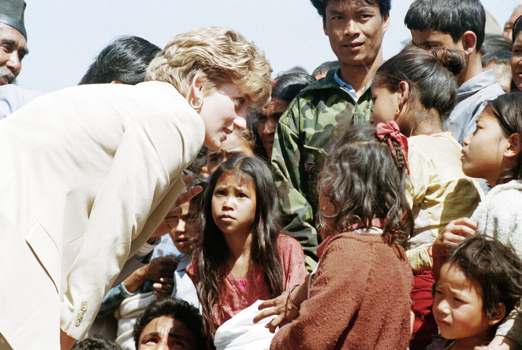 In this file photo dated Friday, March 5, 1993, Britain's Diana talks with Nepalese children in the village of Panauti, in the foothills of the Himalayas, as some thousands of villagers, mostly children, turned out to greet her. (AP Photo/Barbara Walton, File)