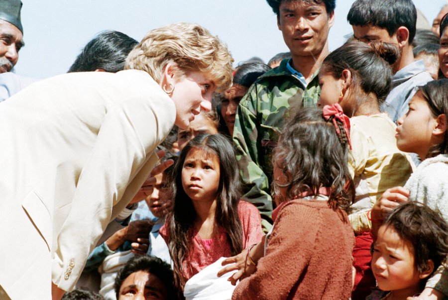 In this file photo dated Friday, March 5, 1993, Britain's Diana talks with Nepalese children in the village of Panauti, in the foothills of the Himalayas, as some thousands of villagers, mostly children, turned out to greet her. (AP Photo/Barbara Walton, File)