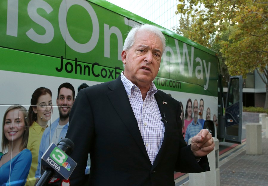 Republican gubernatorial candidate John Cox talks to reporters before beginning a statewide bus tour in Sacramento on Nov. 1, 2018. (Rich Pedroncelli / Associated Press)