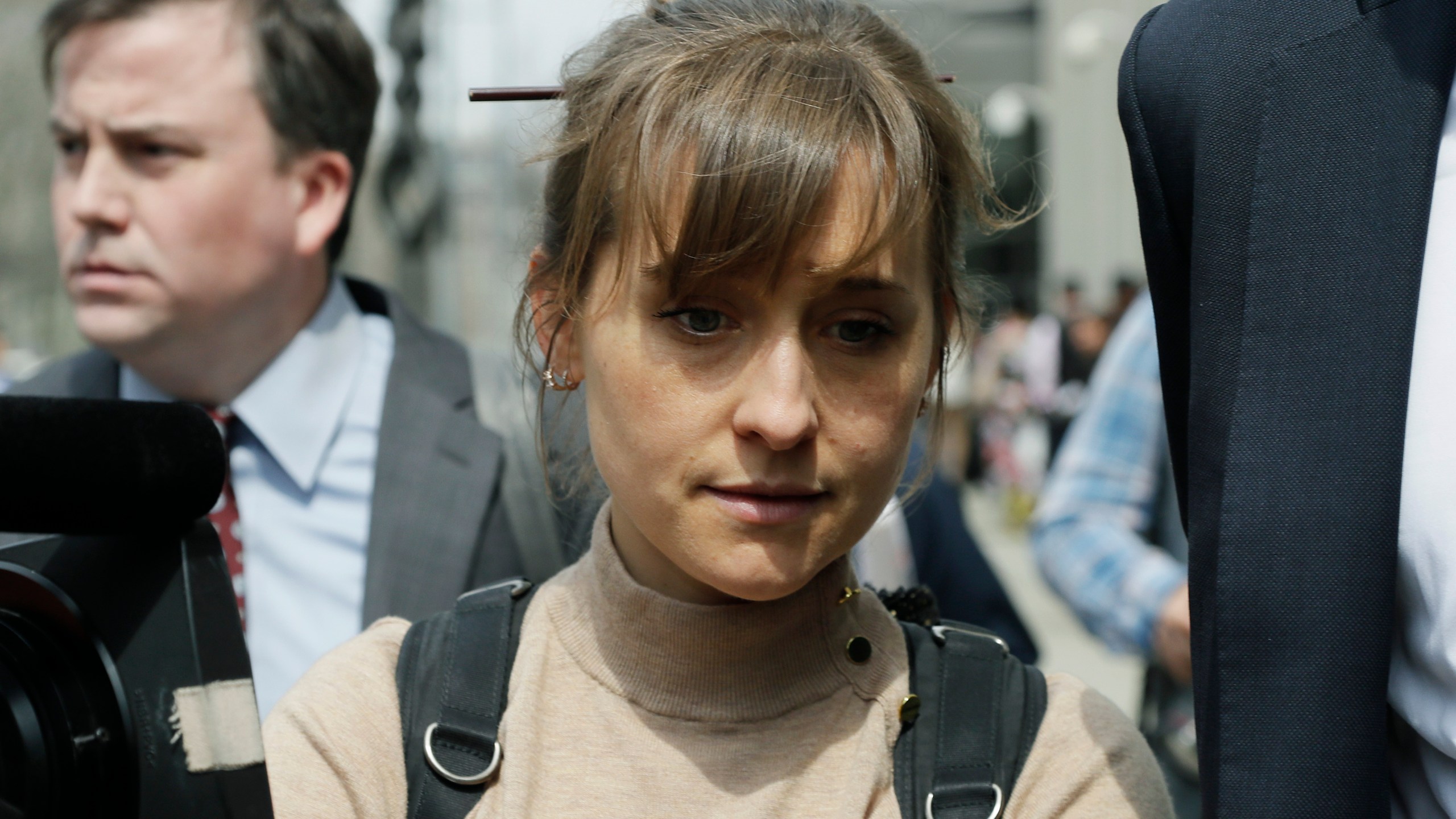 In this Monday, April 8, 2019, file photo, actress Allison Mack leaves Brooklyn federal court in New York. Mack, who played a key role in a scandal-ridden, cult-like upstate New York group, is facing sentencing on June 30, 2021, after pleading guilty to charges she manipulated women into becoming sex slaves for the group’s spiritual leader. (AP Photo/Mark Lennihan, File)