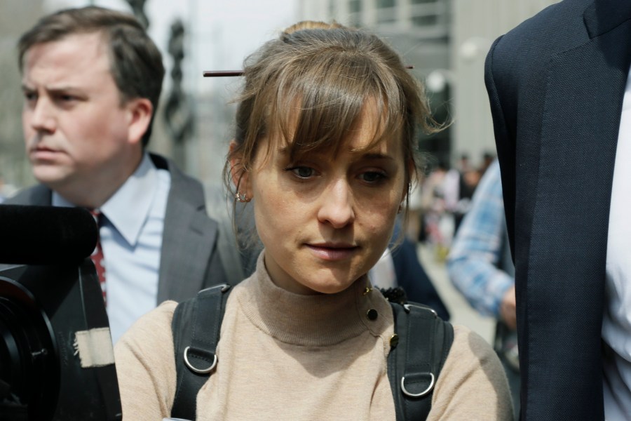 In this Monday, April 8, 2019, file photo, actress Allison Mack leaves Brooklyn federal court in New York. Mack, who played a key role in a scandal-ridden, cult-like upstate New York group, is facing sentencing on June 30, 2021, after pleading guilty to charges she manipulated women into becoming sex slaves for the group’s spiritual leader. (AP Photo/Mark Lennihan, File)