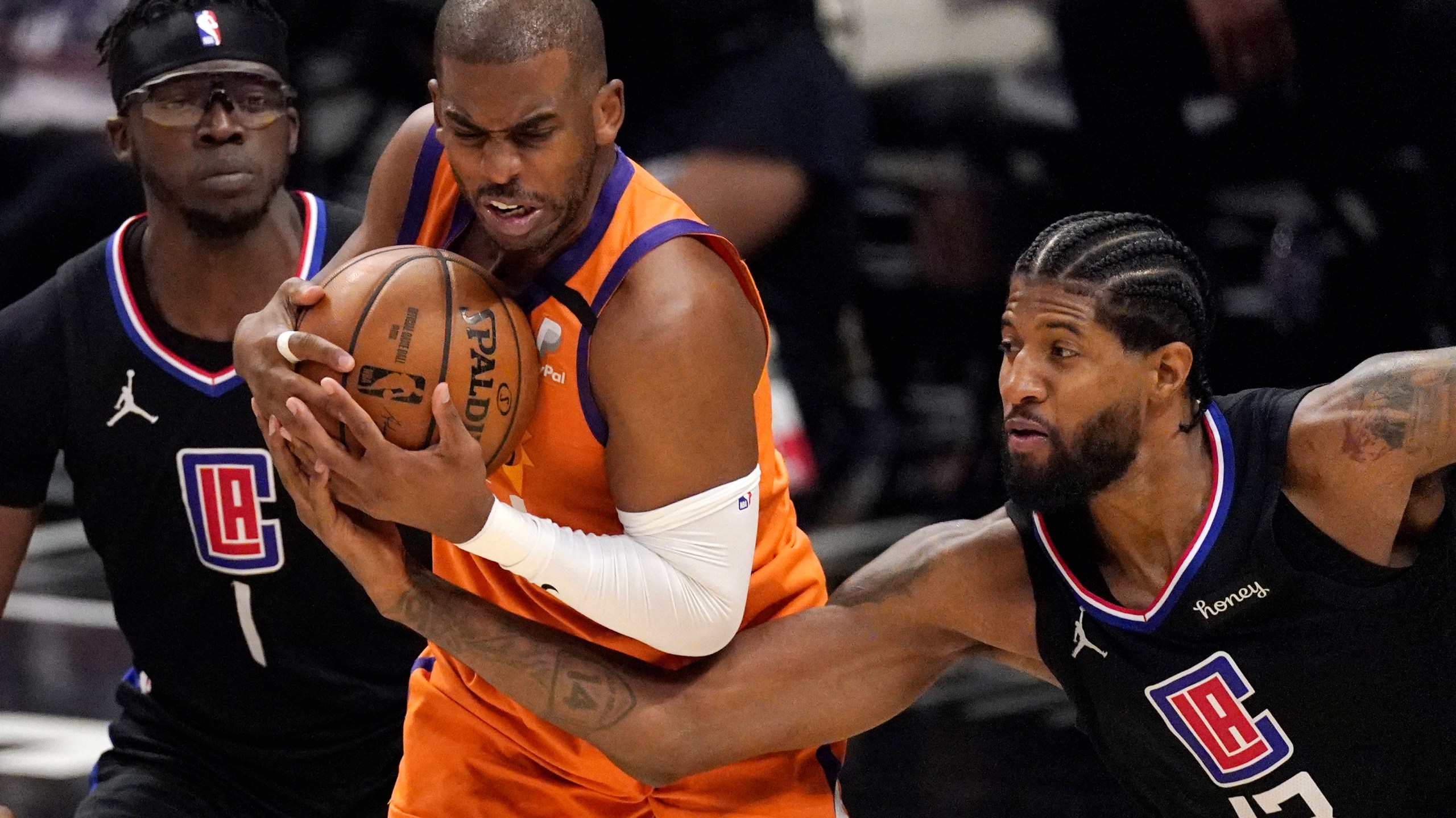 Los Angeles Clippers guard Paul George, right, reaches in on Phoenix Suns guard Chris Paul during the second half in Game 6 of the NBA basketball Western Conference Finals on June 30, 2021, in Los Angeles. (AP Photo/Mark J. Terrill)