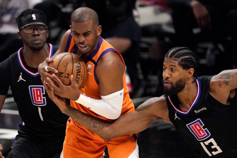 Los Angeles Clippers guard Paul George, right, reaches in on Phoenix Suns guard Chris Paul during the second half in Game 6 of the NBA basketball Western Conference Finals on June 30, 2021, in Los Angeles. (AP Photo/Mark J. Terrill)