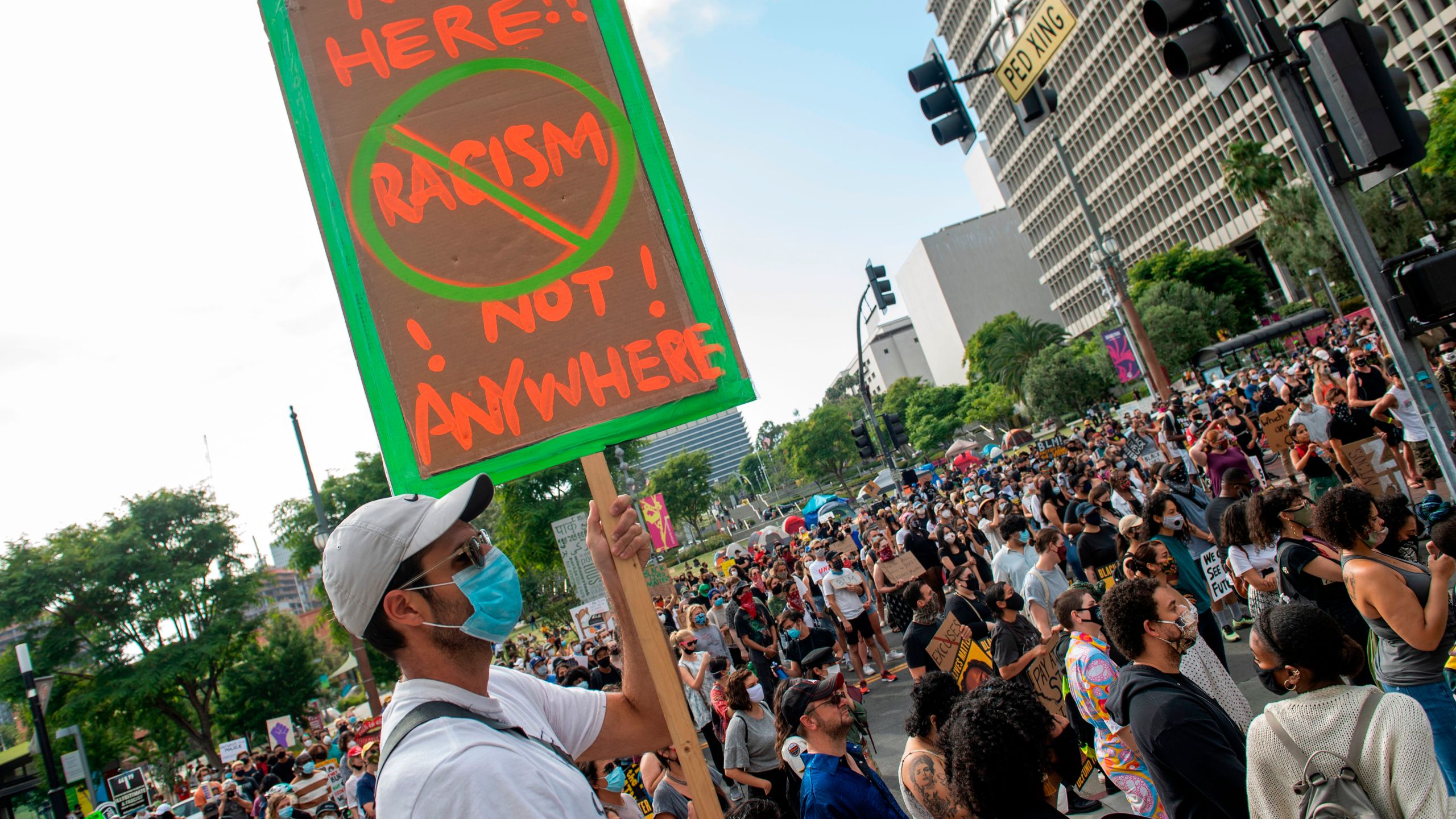 Protesters holding signs gather at the LA City hall to celebrate Juneteenth, June 19, 2020, in Los Angeles, California. - The US marks the end of slavery by celebrating Juneteenth, with the annual unofficial holiday taking on renewed significance as millions of Americans confront the nation's living legacy of racial injustice. (Valerie Maccon/ AFP)