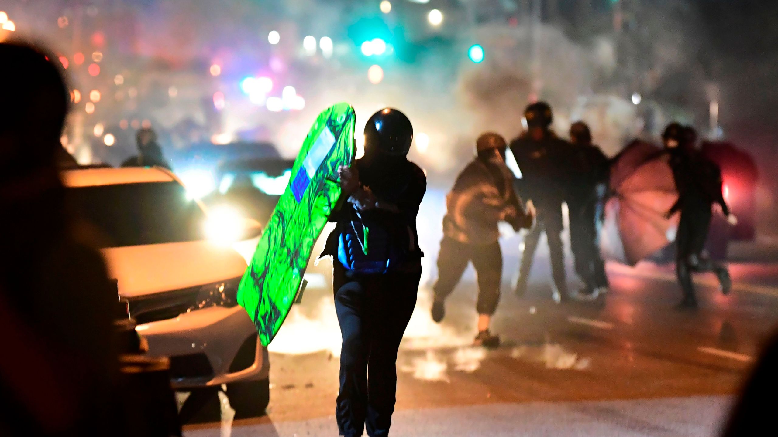 People run from tear gas and rubber bullets fired by Los Angeles County sheriff's deputies dispersing a crowd of demonstrators gathered to protest again in the wake of Dijon Kizzee's killing, outside the South LA sheriff's station on September 8, 2020 in Los Angeles, California. (Frederic J. Brown/AFP via Getty Images)