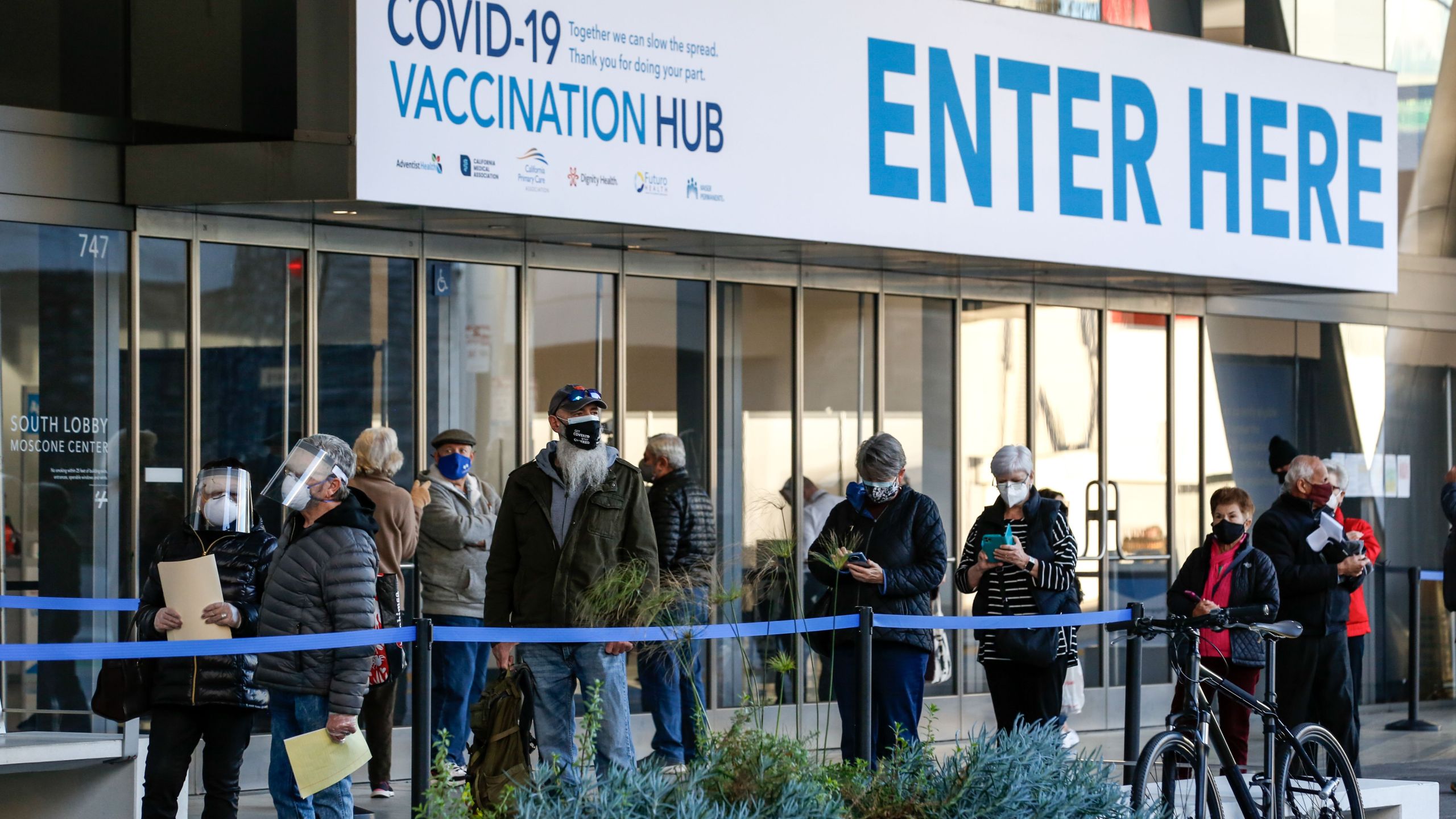 People stand in line at the mass vaccination site at San Francisco's Moscone Convention Center on Feb. 5, 2021. (AMY OSBORNE/AFP via Getty Images)