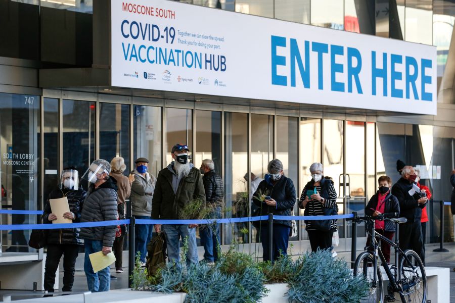 People stand in line at the mass vaccination site at San Francisco's Moscone Convention Center on Feb. 5, 2021. (AMY OSBORNE/AFP via Getty Images)