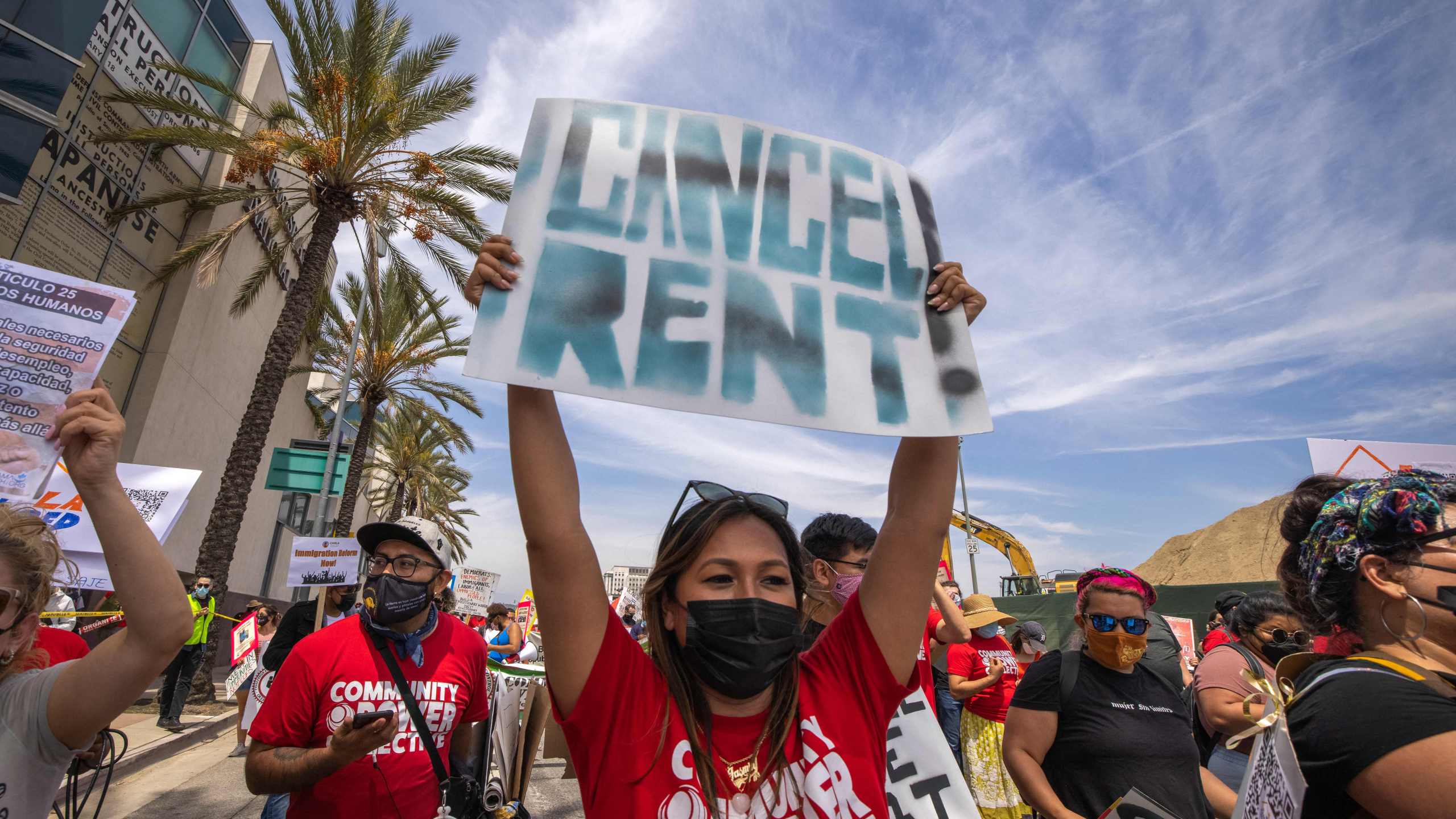 A woman calls for rent relief as a coalition of activist groups and labor unions participate in a May Day march for workers' and human rights in Los Angeles on May 1, 2021. (David McNew / AFP / Getty Images)