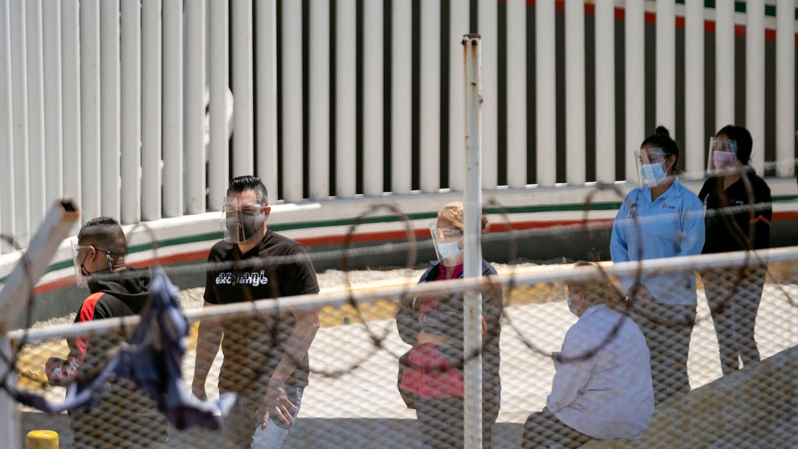 Maquila workers line up to cross the border and get vaccinated against COVID-19 on the U.S. side as seen from El Chaparral crossing port of Tijuana, Baja California state, Mexico on May 25, 2021. (GUILLERMO ARIAS/AFP via Getty Images)