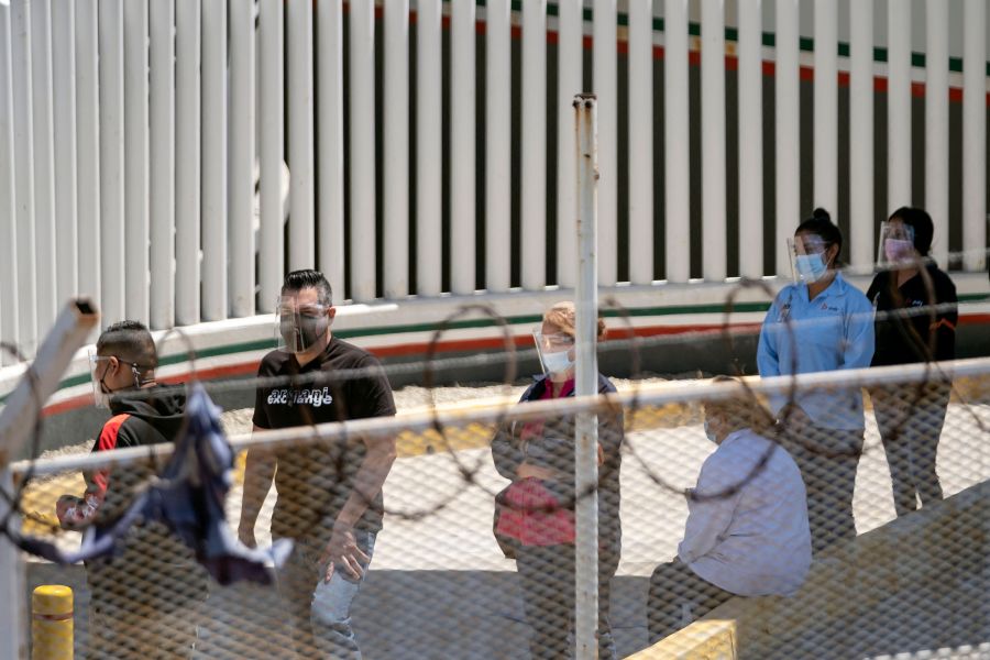 Maquila workers line up to cross the border and get vaccinated against COVID-19 on the U.S. side as seen from El Chaparral crossing port of Tijuana, Baja California state, Mexico on May 25, 2021. (GUILLERMO ARIAS/AFP via Getty Images)