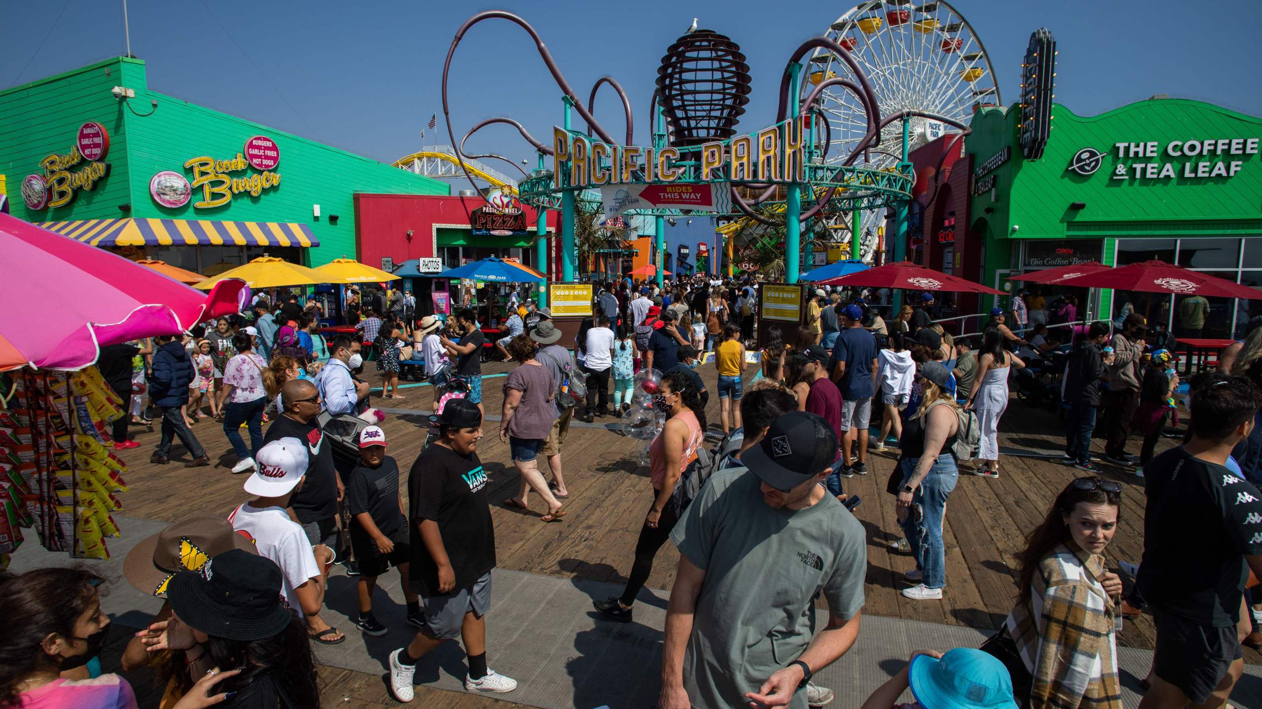 People walk through the Santa Monica pier ahead of Memorial Day in Santa Monica, California on May 29, 2021. (Photo by Apu Gomes / AFP)