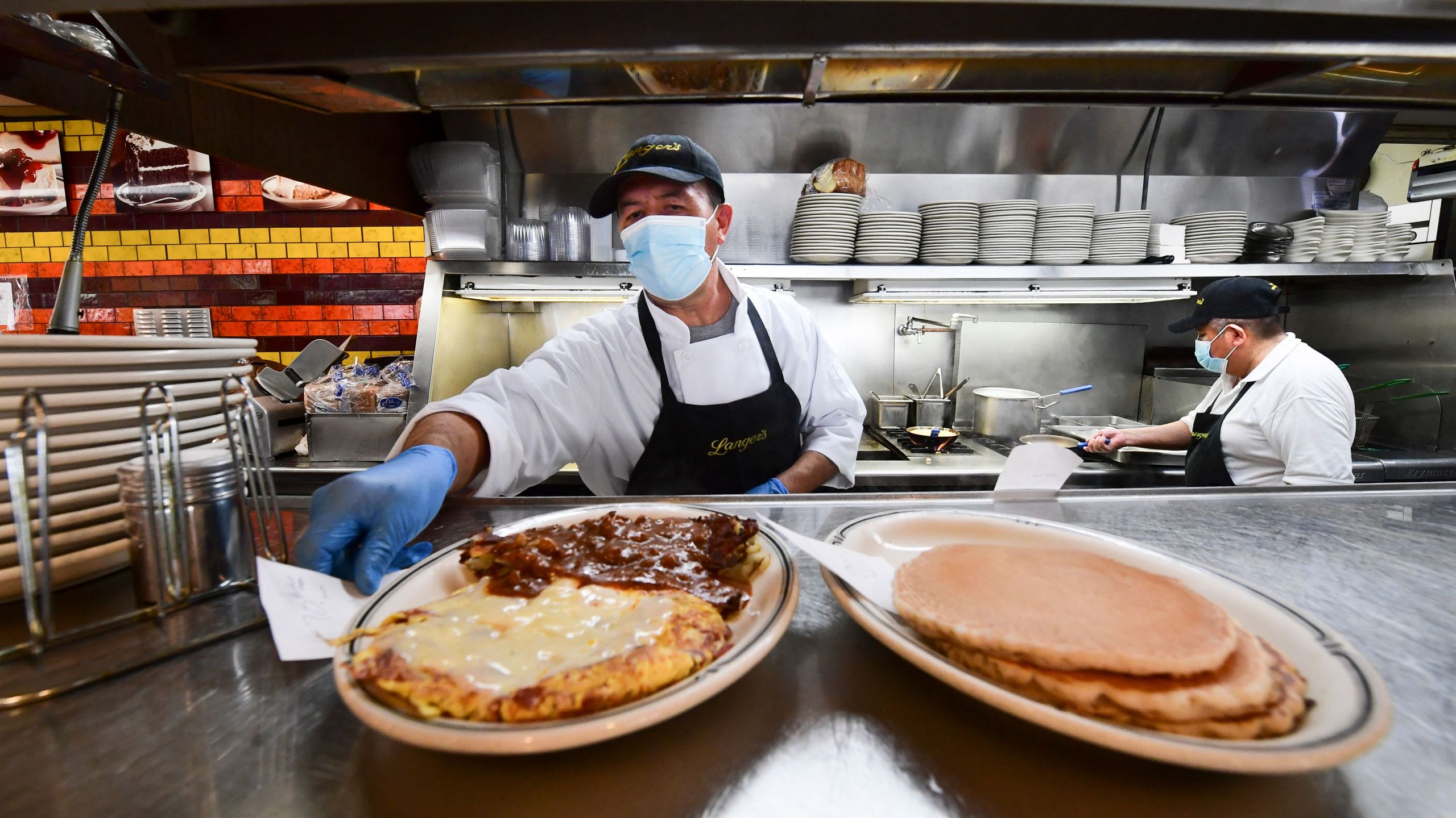 Kitchen staff prepare breakfast at restaurant in Los Angeles on June 15, 2021. Frederic J. Brown/AFP via Getty Images)