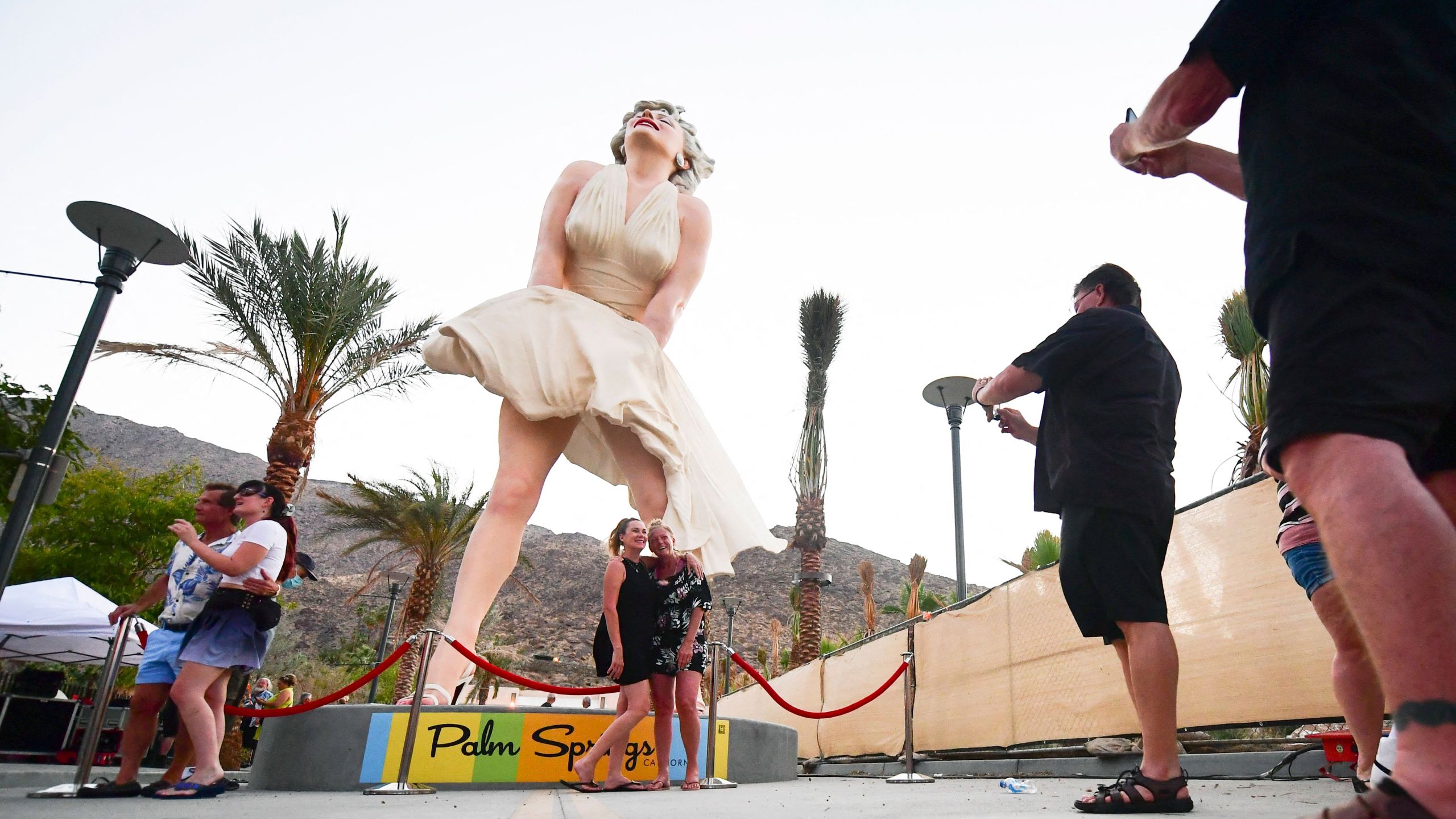 People visit the Forever Marilyn statue on its return to Palm Springs on June 20. Three days later, Palm Springs had rainfall — the city’s first recorded rainfall on June 23 since 1922.(Frederic J. Brown / AFP / Getty Images)