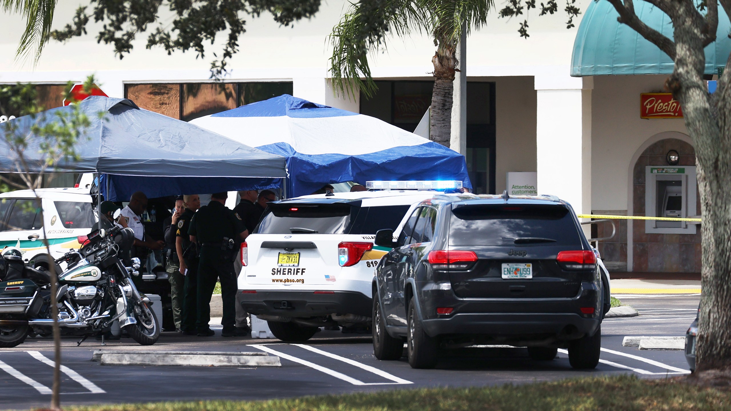 Palm Beach County Sheriff’s officers stand outside of a Publix supermarket in Royal Palm Beach, Florida, where a woman, child and a man were found shot to death on June 10, 2021. (Joe Raedle / Getty Images)