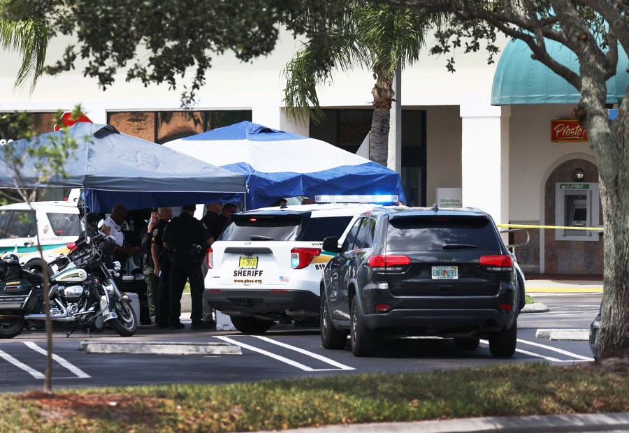 Palm Beach County Sheriff’s officers stand outside of a Publix supermarket in Royal Palm Beach, Florida, where a woman, child and a man were found shot to death on June 10, 2021. (Joe Raedle / Getty Images)