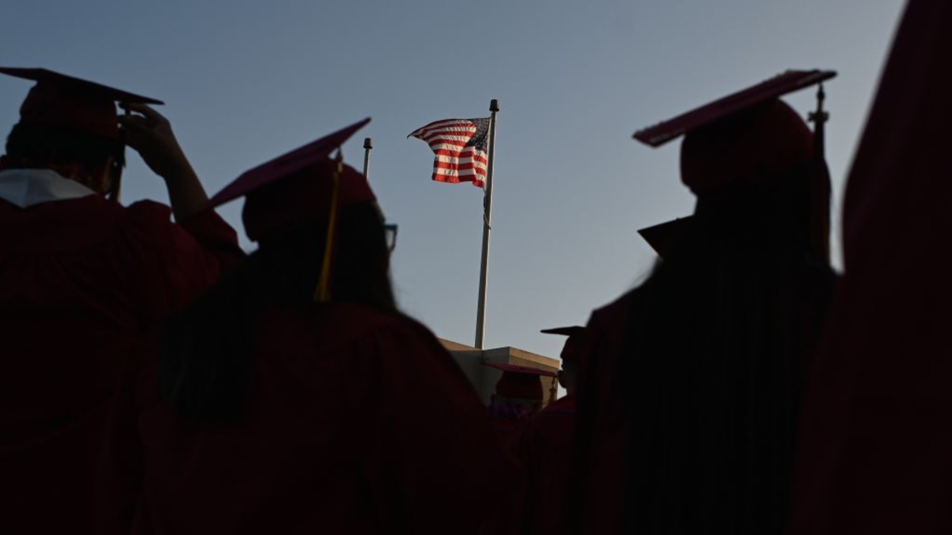 A US flag flies above a building as students earning degrees at Pasadena City College participate in the graduation ceremony, June 14, 2019, in Pasadena, California. (ROBYN BECK/AFP via Getty Images)