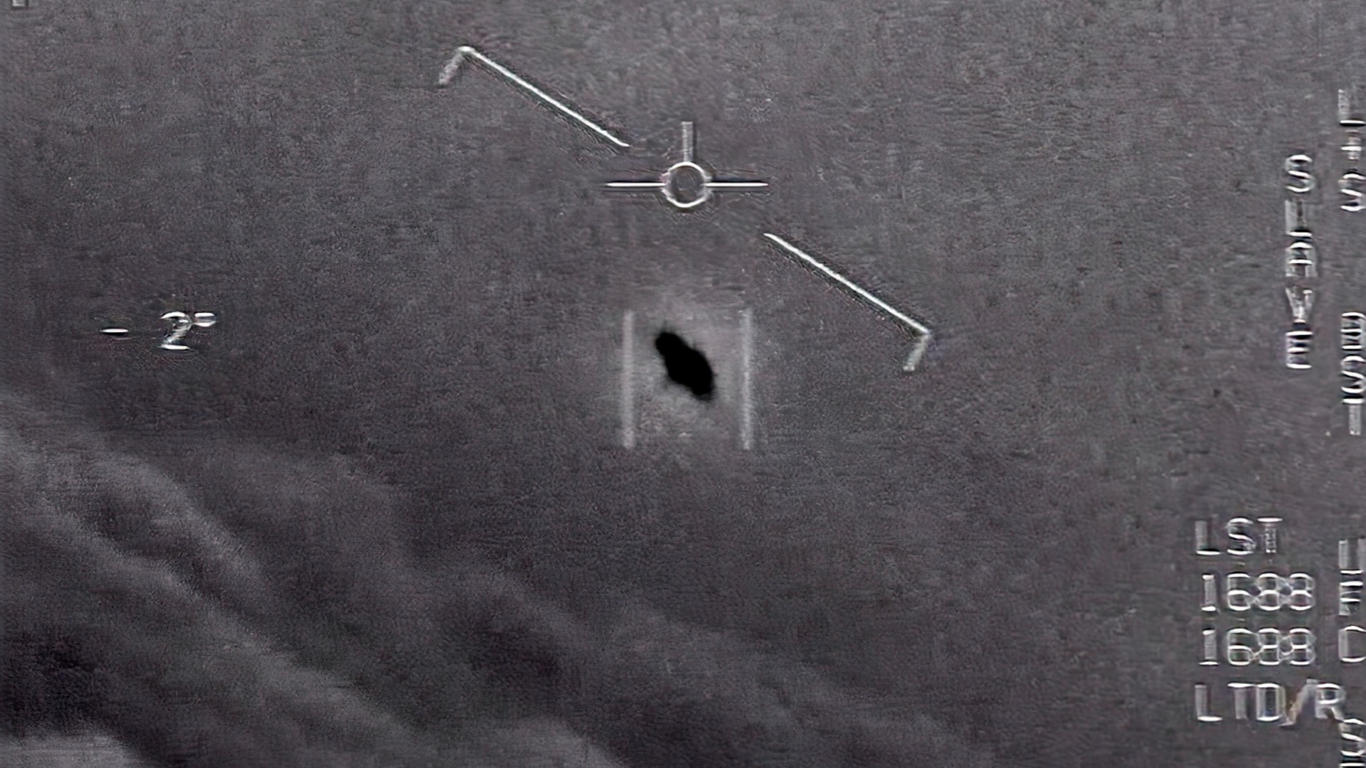 The image from video provided by the Department of Defense labelled Gimbal, from 2015, an unexplained object is seen at center as it is tracked as it soars high along the clouds, traveling against the wind. “There's a whole fleet of them,” one naval aviator tells another, though only one indistinct object is shown. “It's rotating." The U.S. government has been taking a hard look at unidentified flying objects, under orders from Congress, and a report summarizing what officials know is expected to come out in June 2021. (Department of Defense via AP)