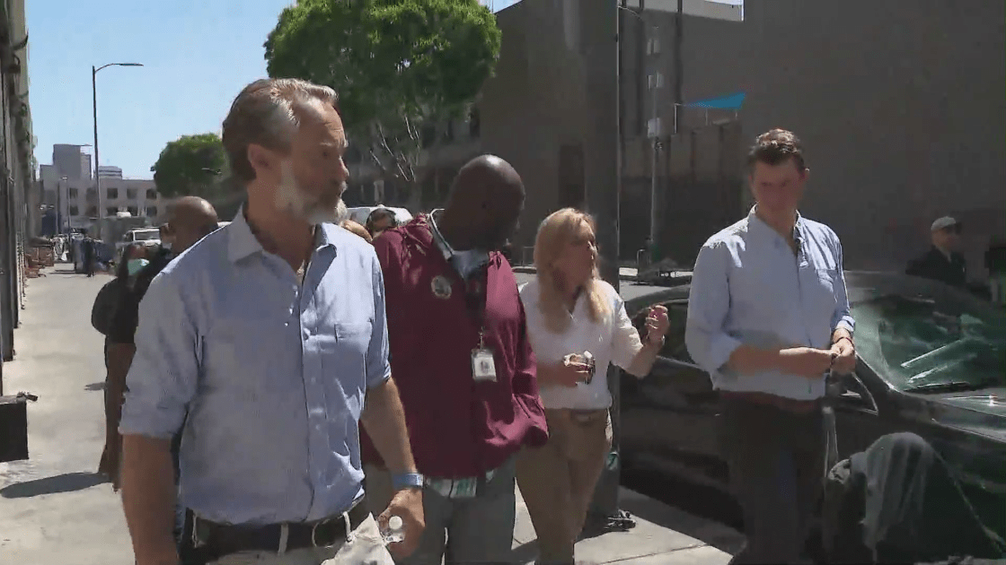 Local and state officials walk along Skid Row on June 11, 2021. (KTLA)