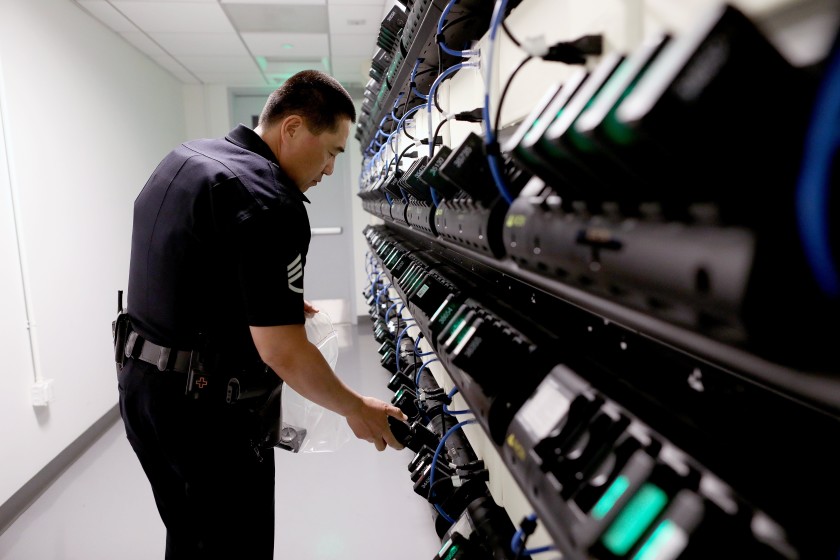 An LAPD officer is seen next to body cameras in an undated photo. (Gary Coronado / Los Angeles Times)