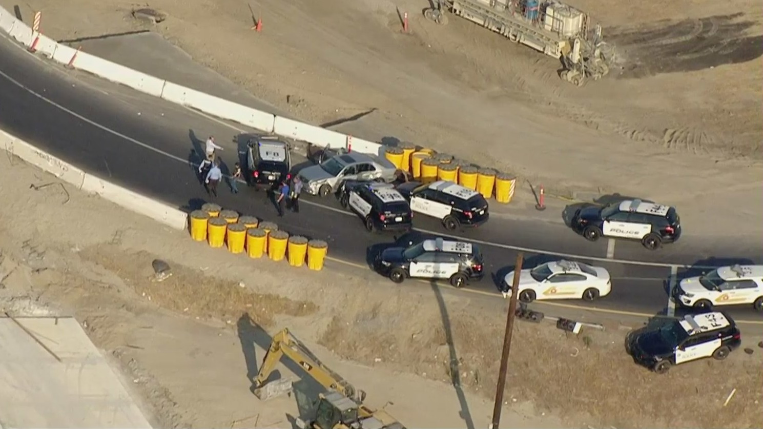 Authorities respond to investigate after a pursuit ended in a police shooting on a 10 Freeway off-ramp in Ontario on July 12, 2021. (KTLA)