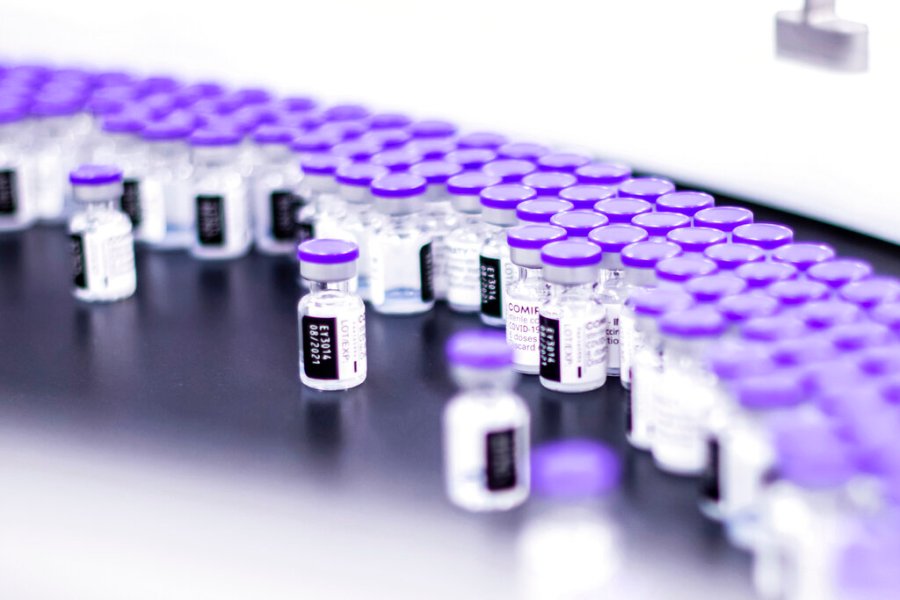 In this March 2021 photo provided by Pfizer, vials of the Pfizer-BioNTech COVID-19 vaccine are prepared for packaging at the company’s facility in Puurs, Belgium. (Pfizer via AP)