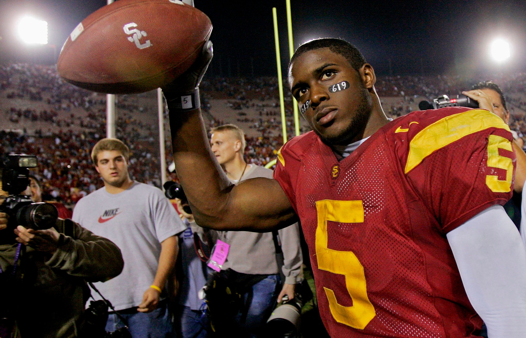 Southern California tail back Reggie Bush walks off the field holding the game ball after the Trojans defeated Fresno State, 50-42, at the Los Angeles Coliseum on Nov. 19, 2005. (Kevork Djansezian / Associated Press)