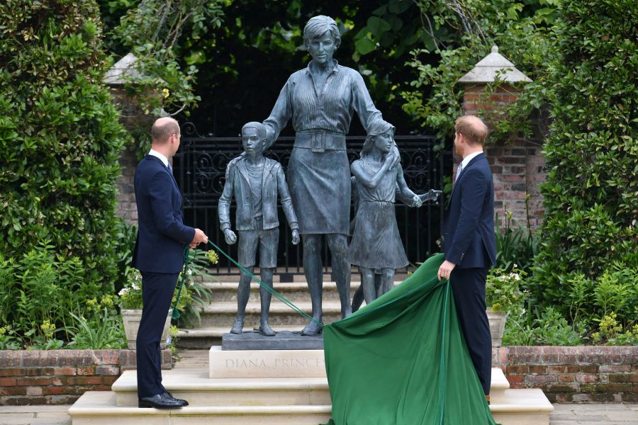 Britain's Prince William, left and Prince Harry unveil a statue they commissioned of their mother Princess Diana,  on what woud have been her 60th birthday, in the Sunken Garden at Kensington Palace, London, Thursday July 1, 2021. (Dominic Lipinski /Pool Photo via AP)